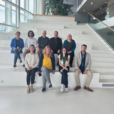 Texas State University and MINES Saint-Etienne leadership pose for a photo together on a staircase.