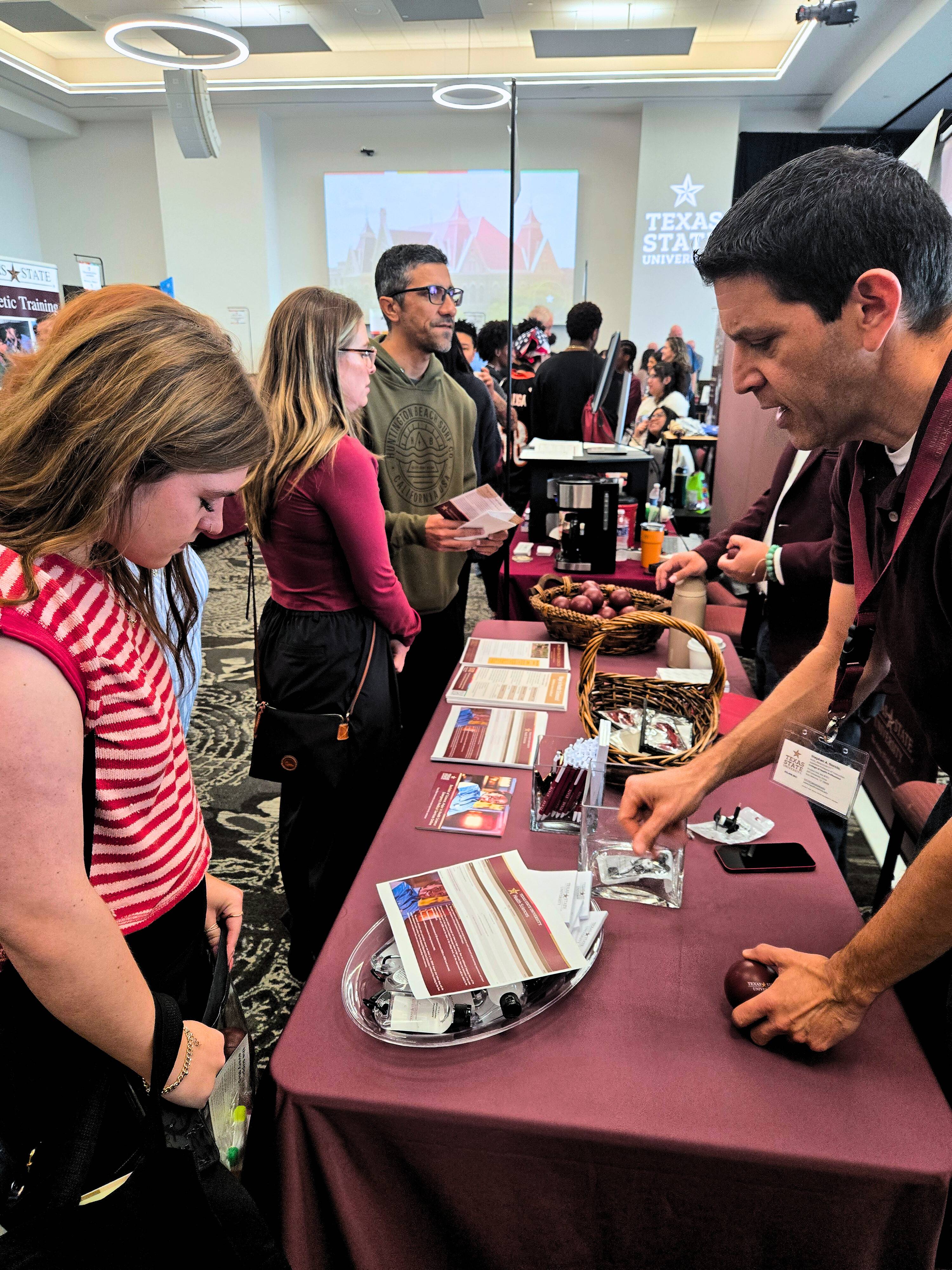 Stephen having conversation with student on Bobcat day