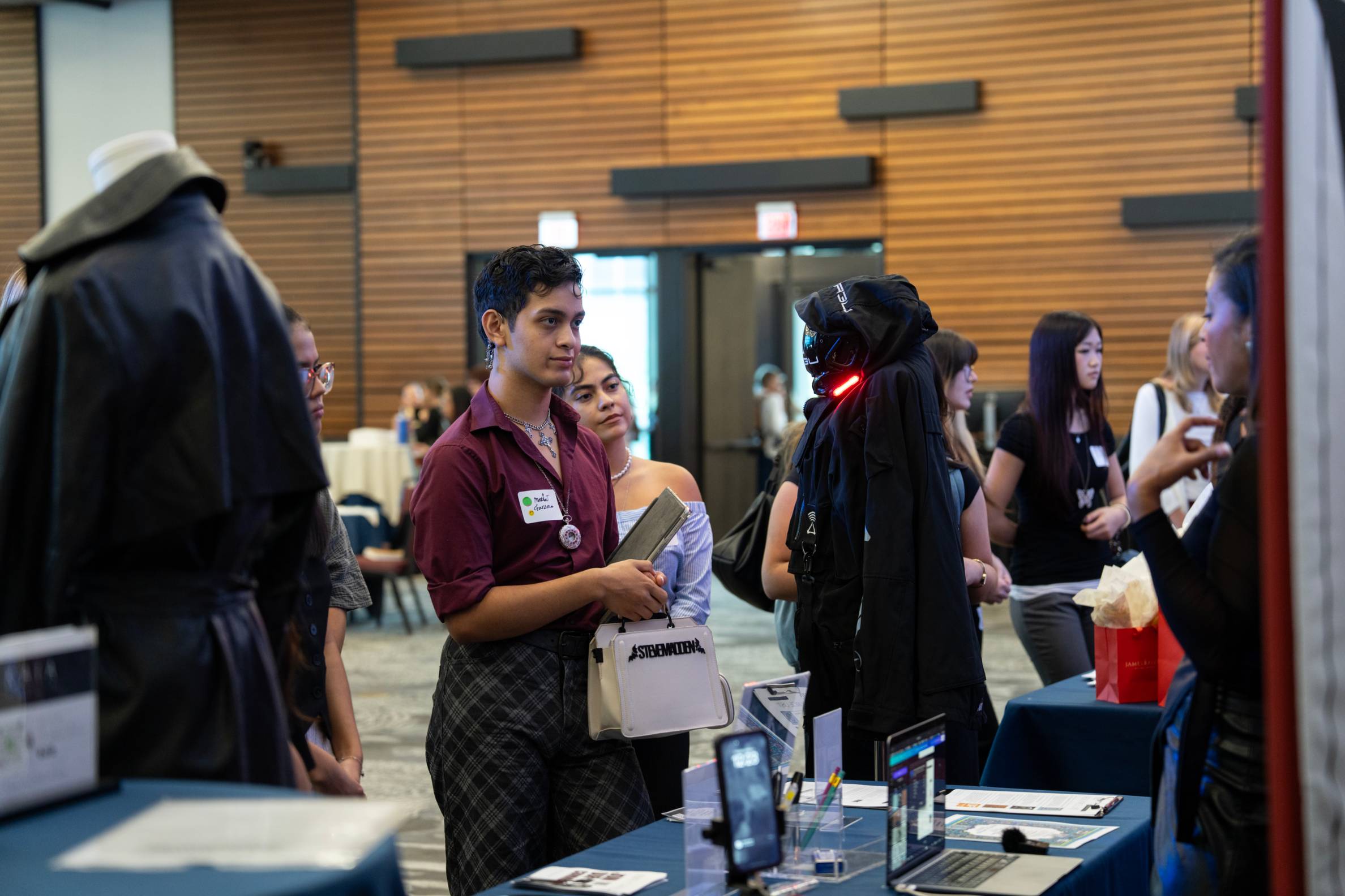Male student speaking to business representative.