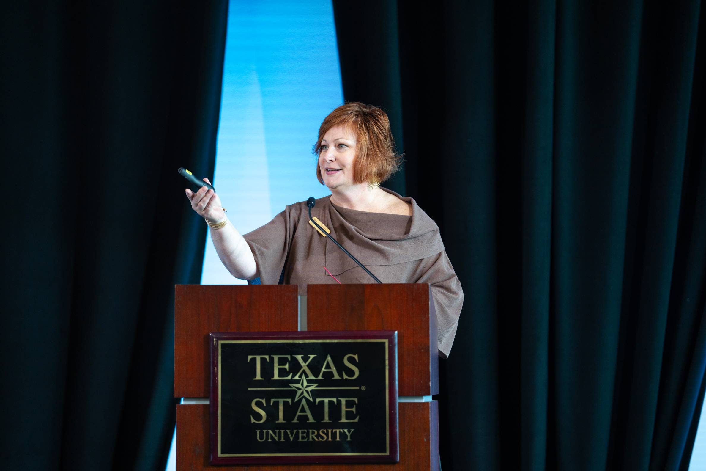 Prof Romo speaking from a podium