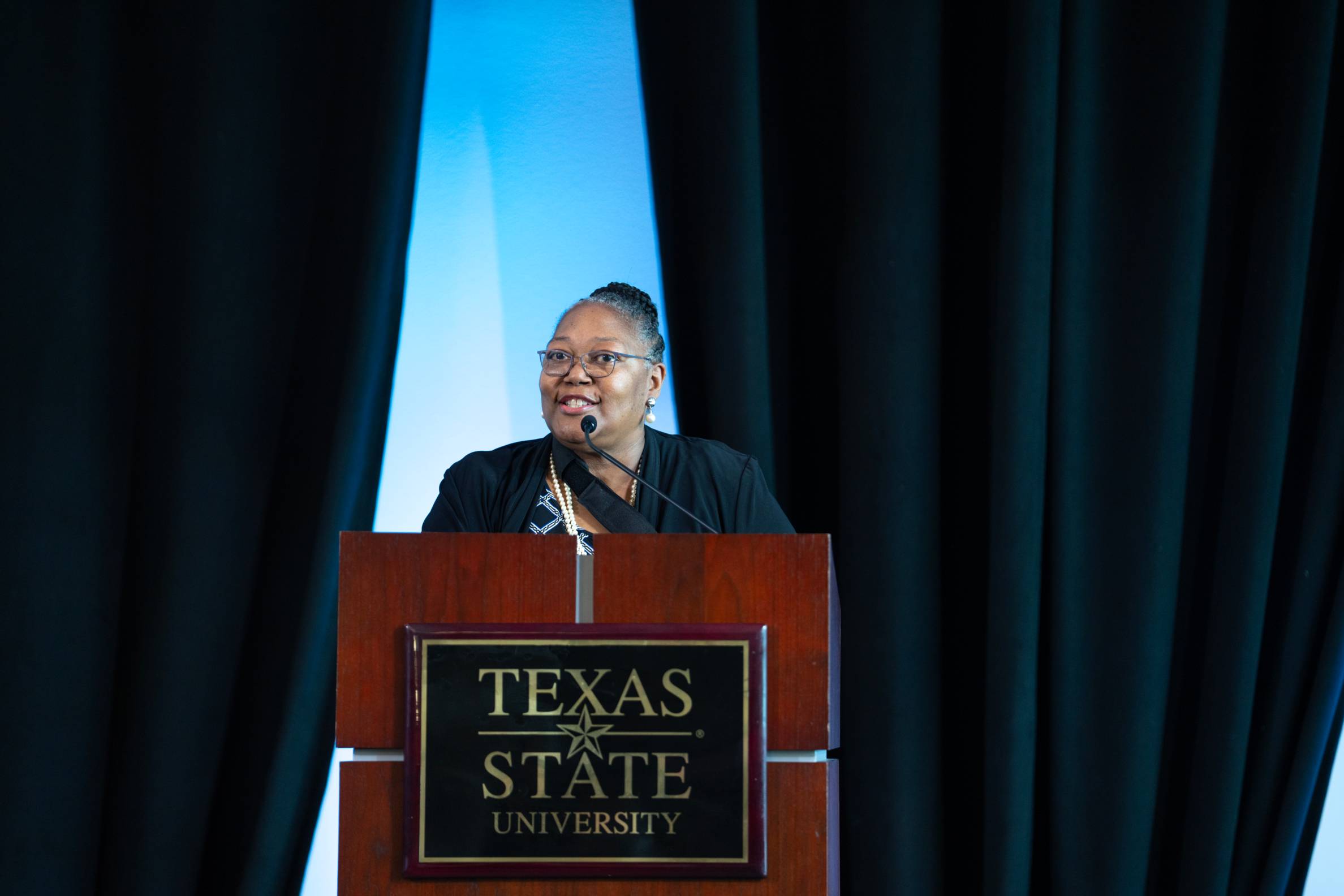 Dean Ausberg speaking from a podium