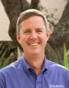man with gray hair and blue shirt