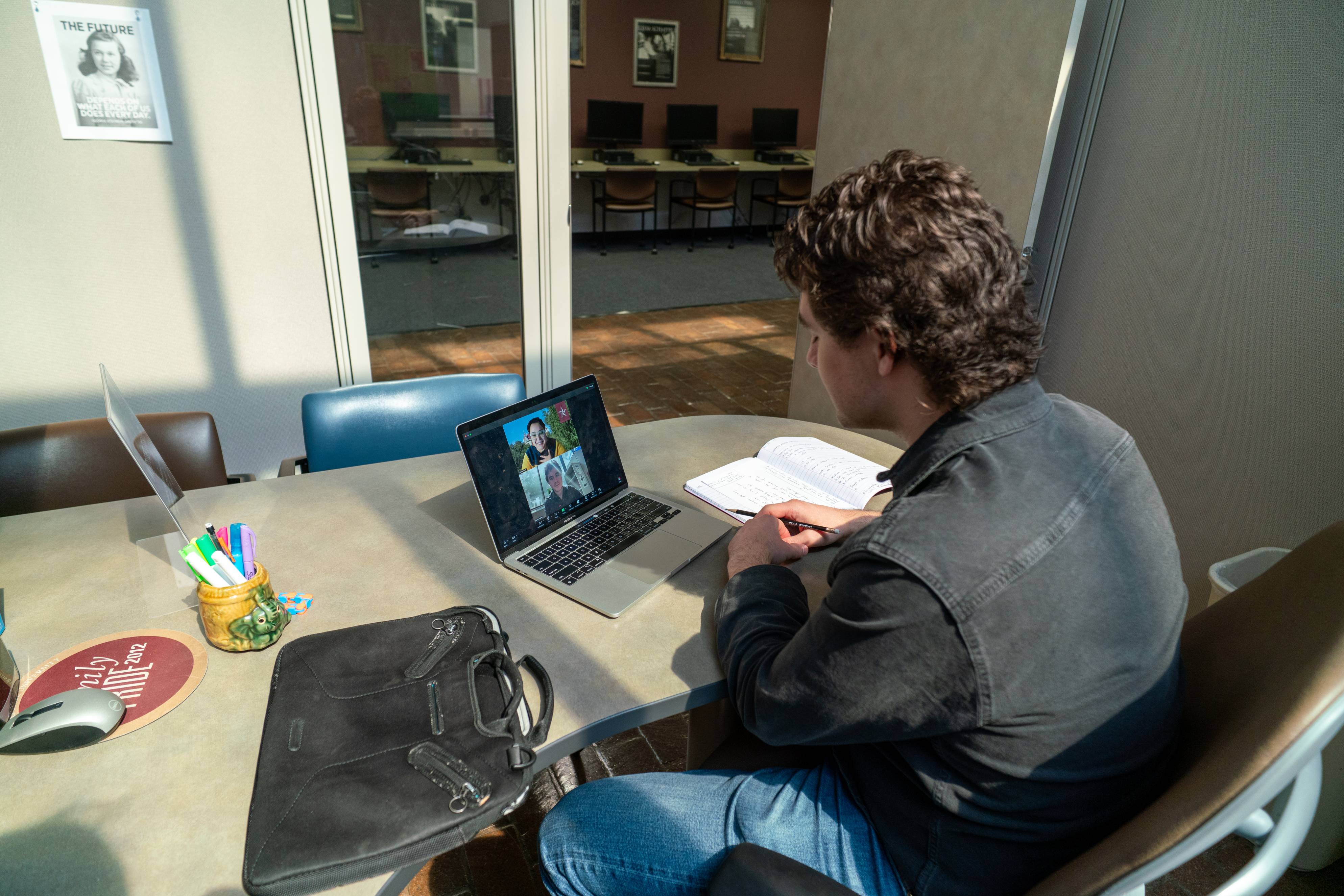 A student using a laptop communicates with others.