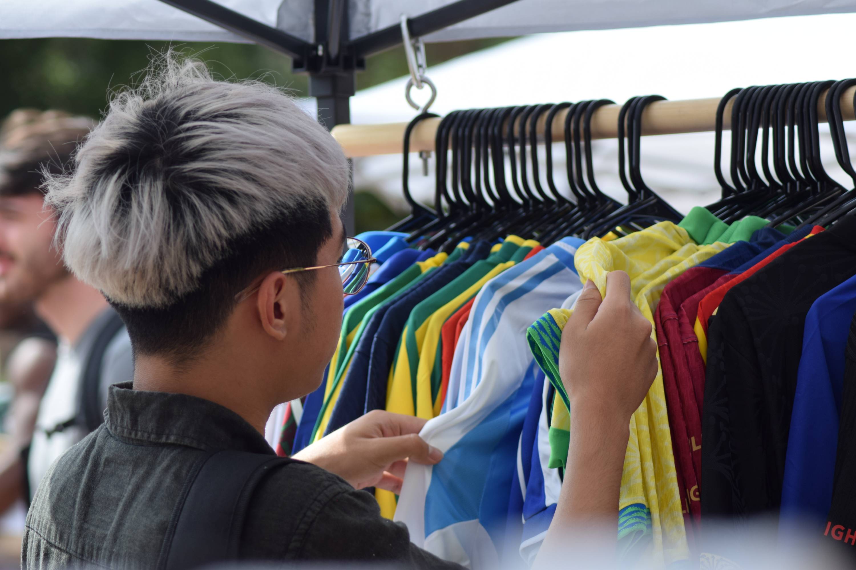 Student at the Bobcat Bazaar looking through clothes.