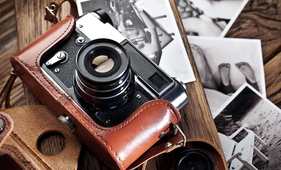 a camera on a desk full of papers