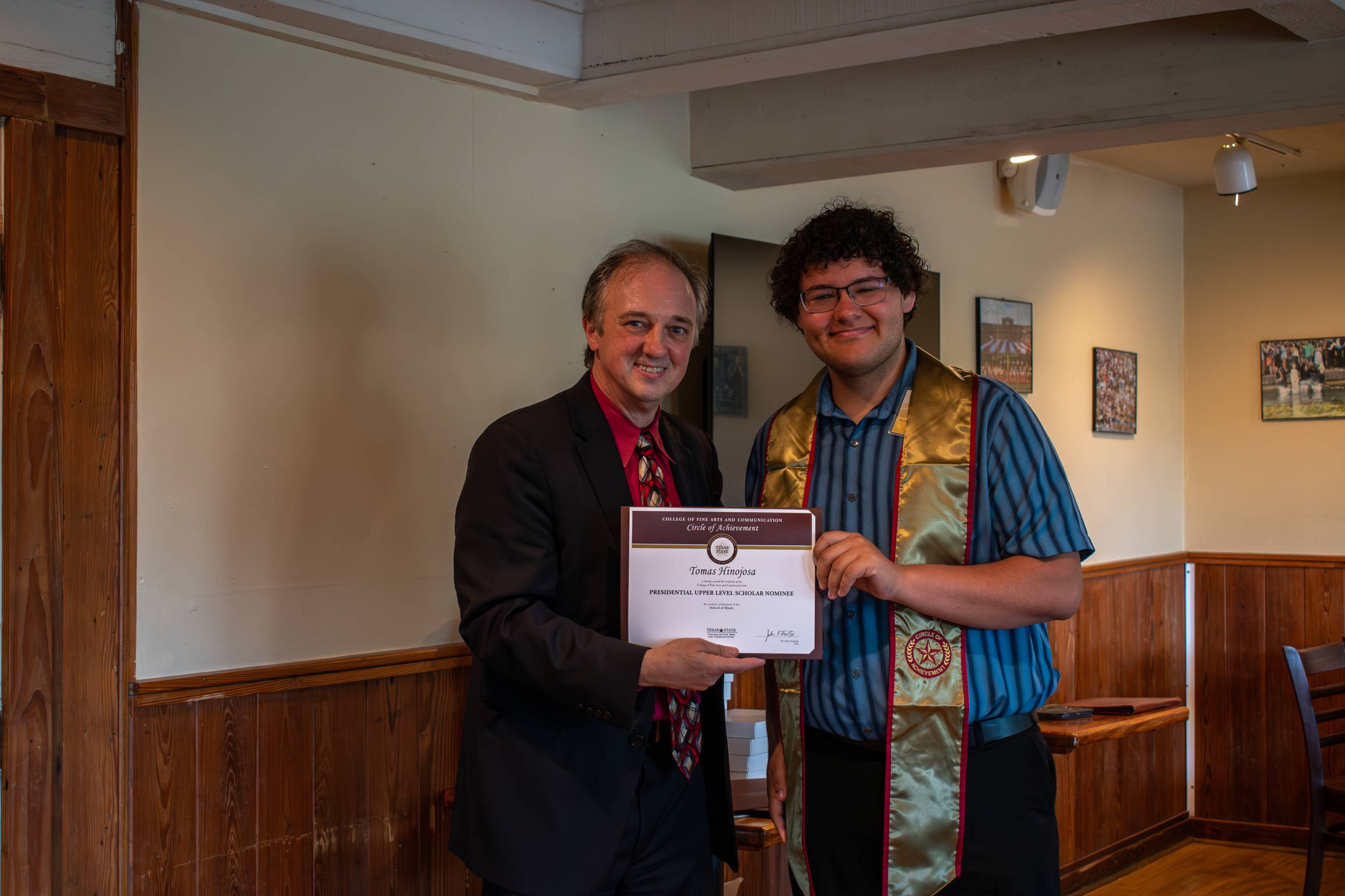 Dean Fleming posing for a photo with a Circle of Achievement recipient