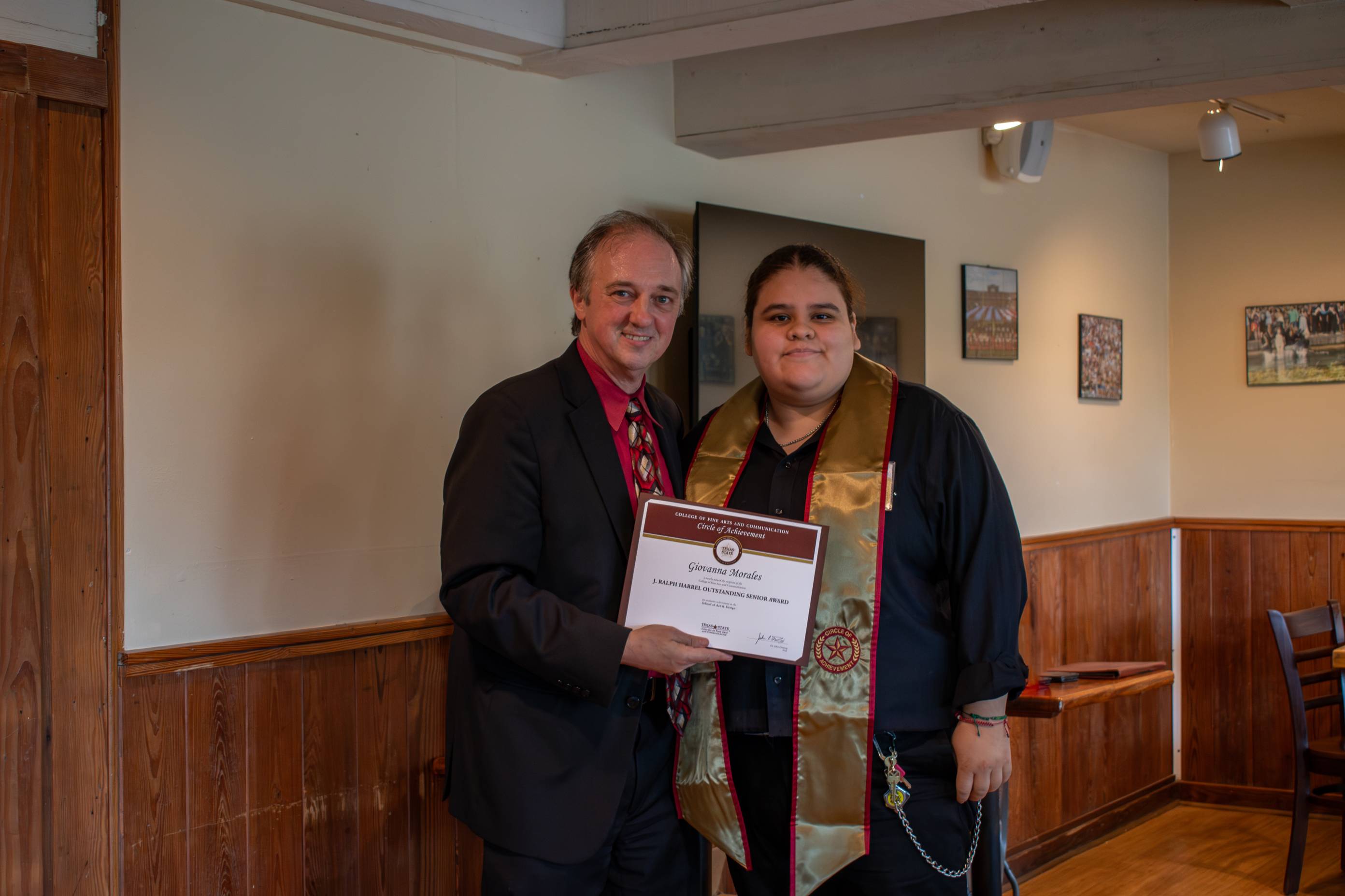Dean Fleming posing for a photo with a Circle of Achievement recipient