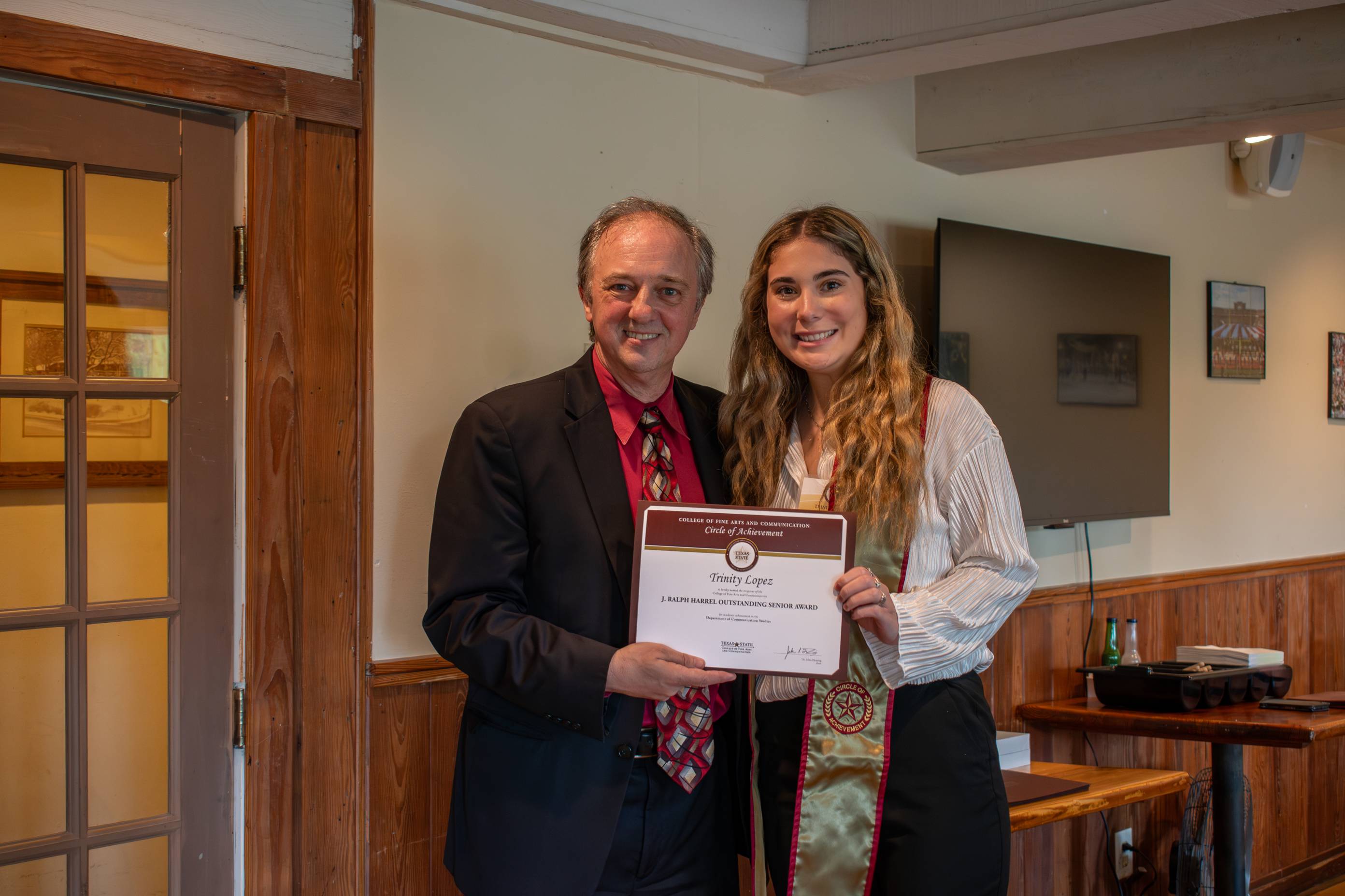 Dean Fleming posing for a photo with a Circle of Achievement recipient
