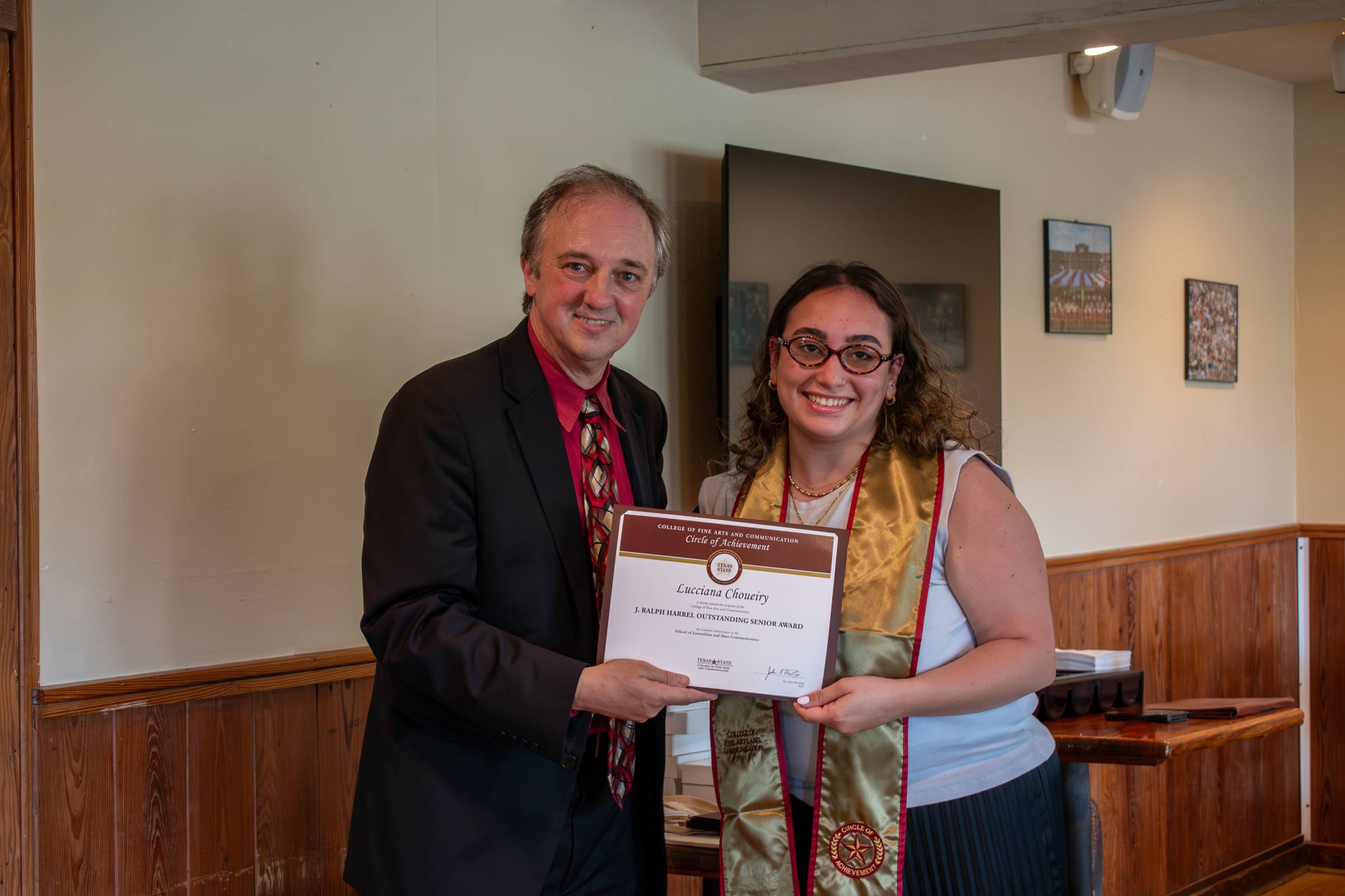 Dean Fleming posing for a photo with a Circle of Achievement recipient