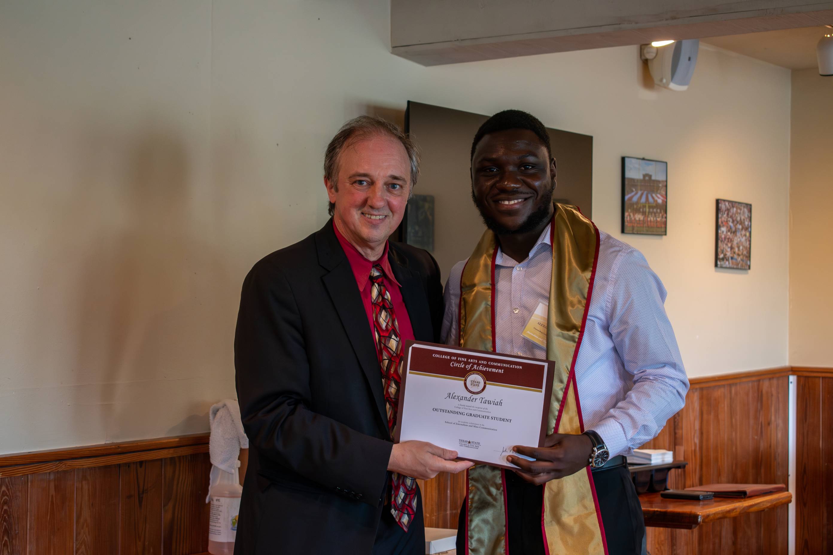 Dean Fleming posing for a photo with a Circle of Achievement recipient