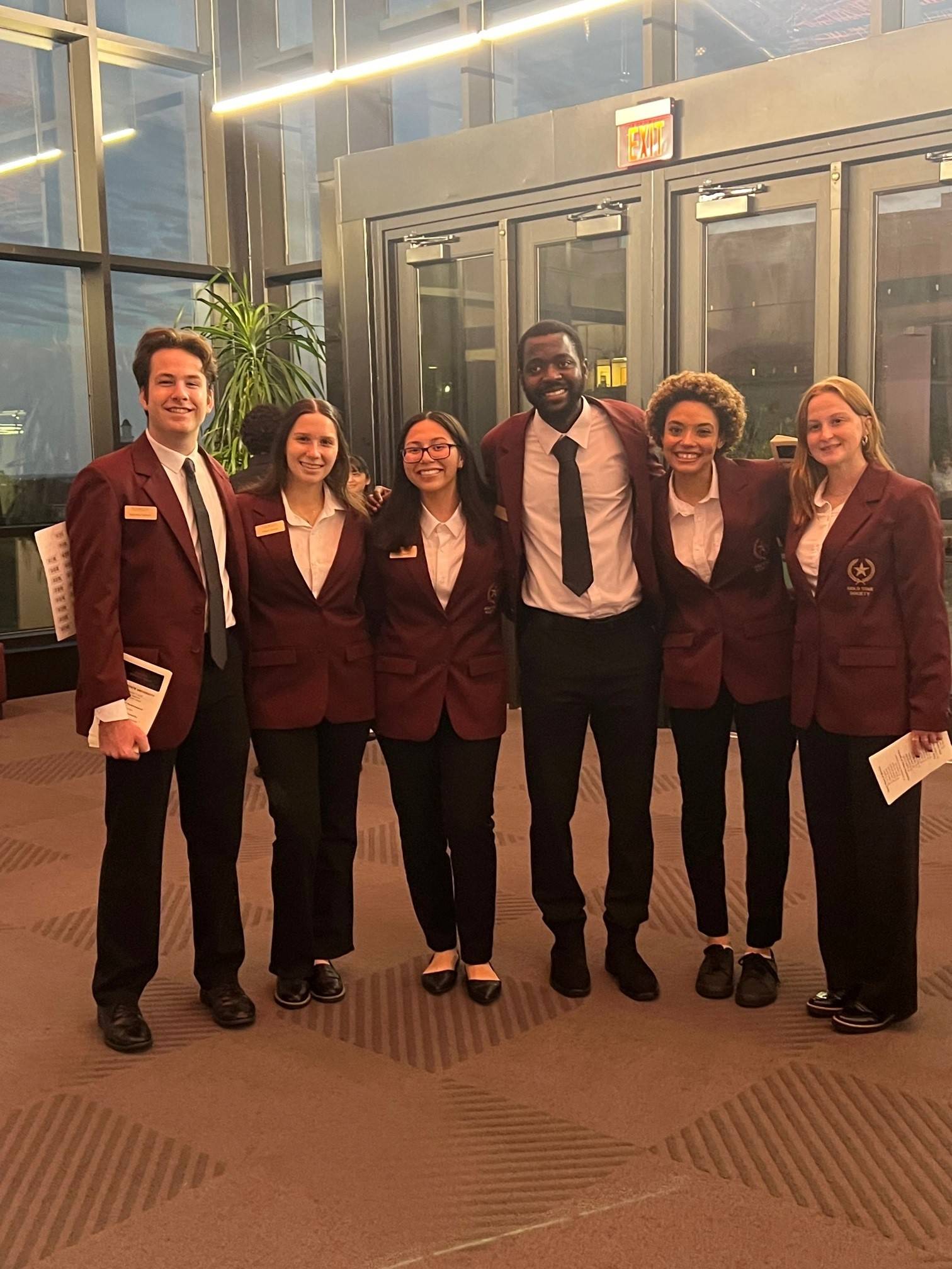 group of people in maroon jackets