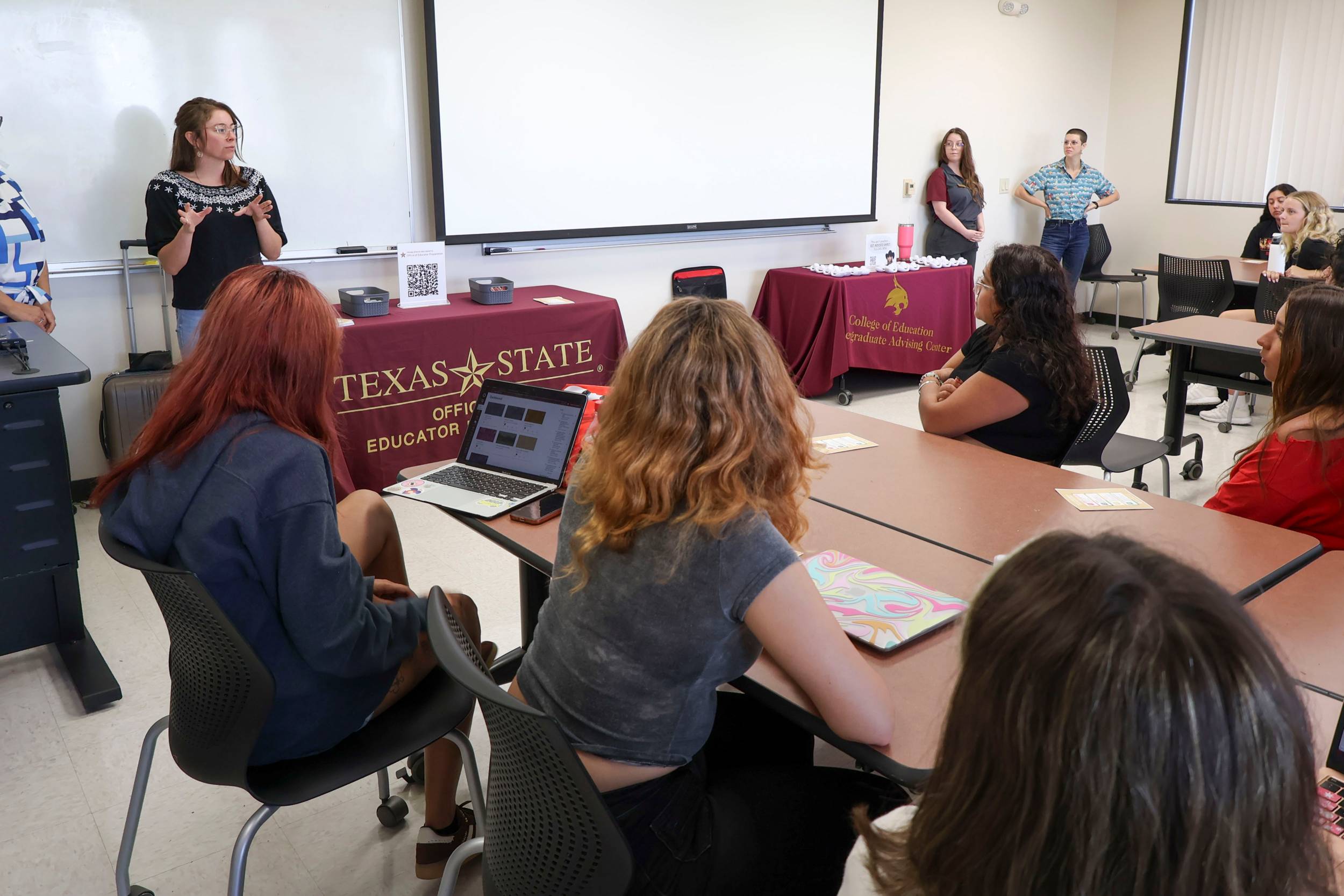 classroom with two women standing in front of students