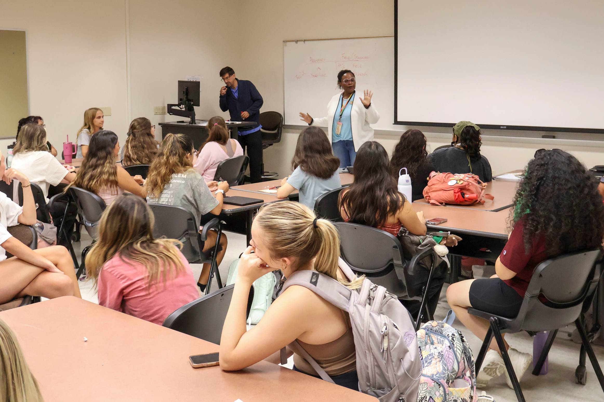 classroom with one women standing in front of students