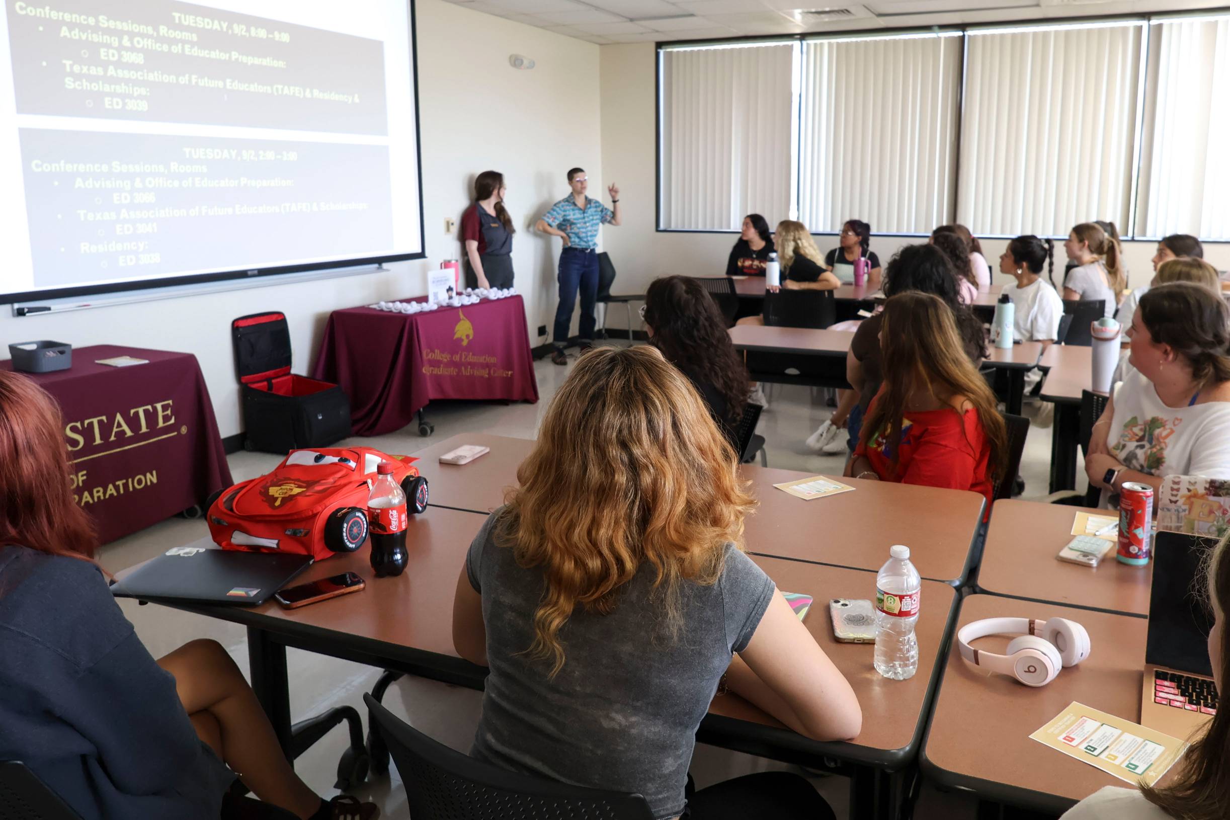 classroom with two women standing in front of students