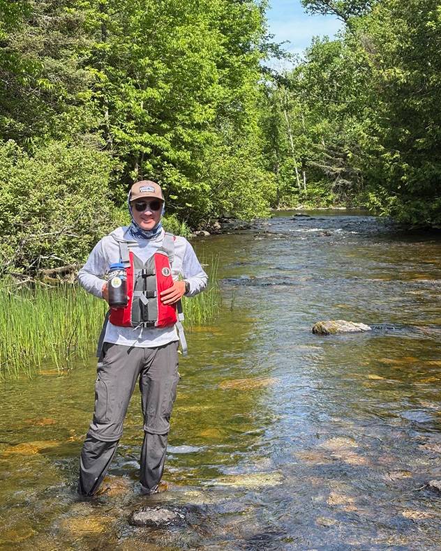 Fischer Marlow stands in a river.