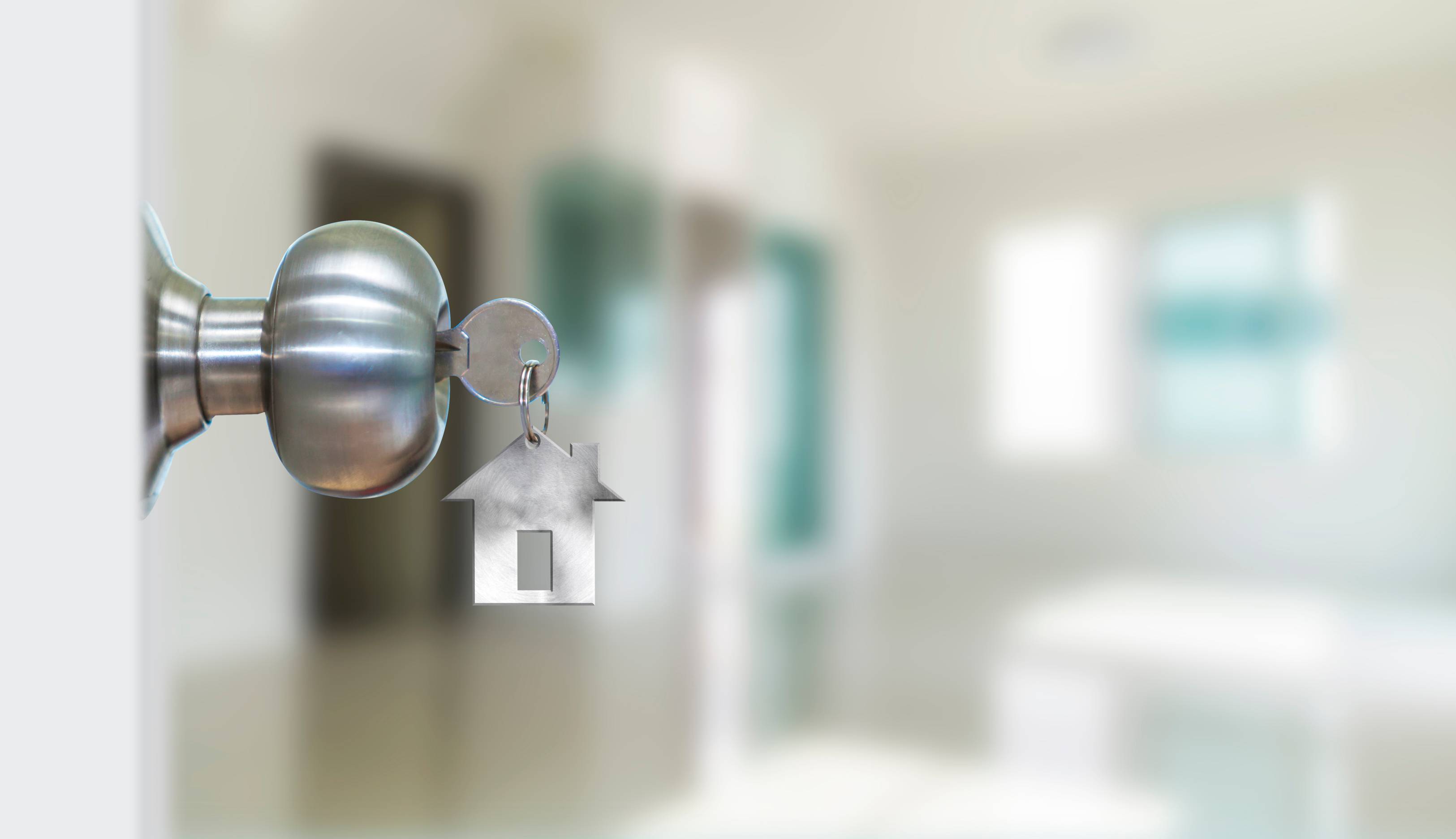 a silver key in a silver doorknob