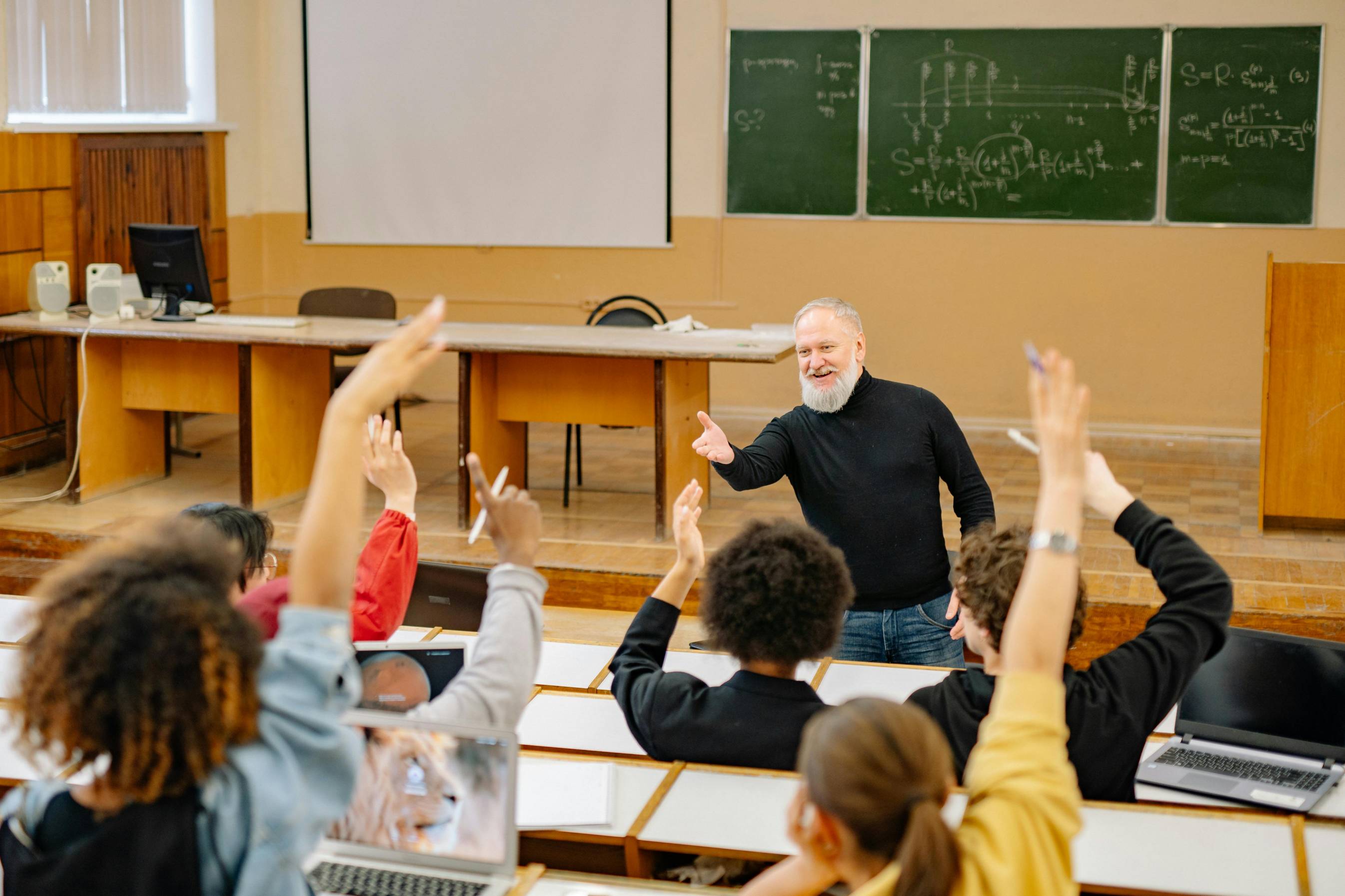 a teacher in a classroom in front of students