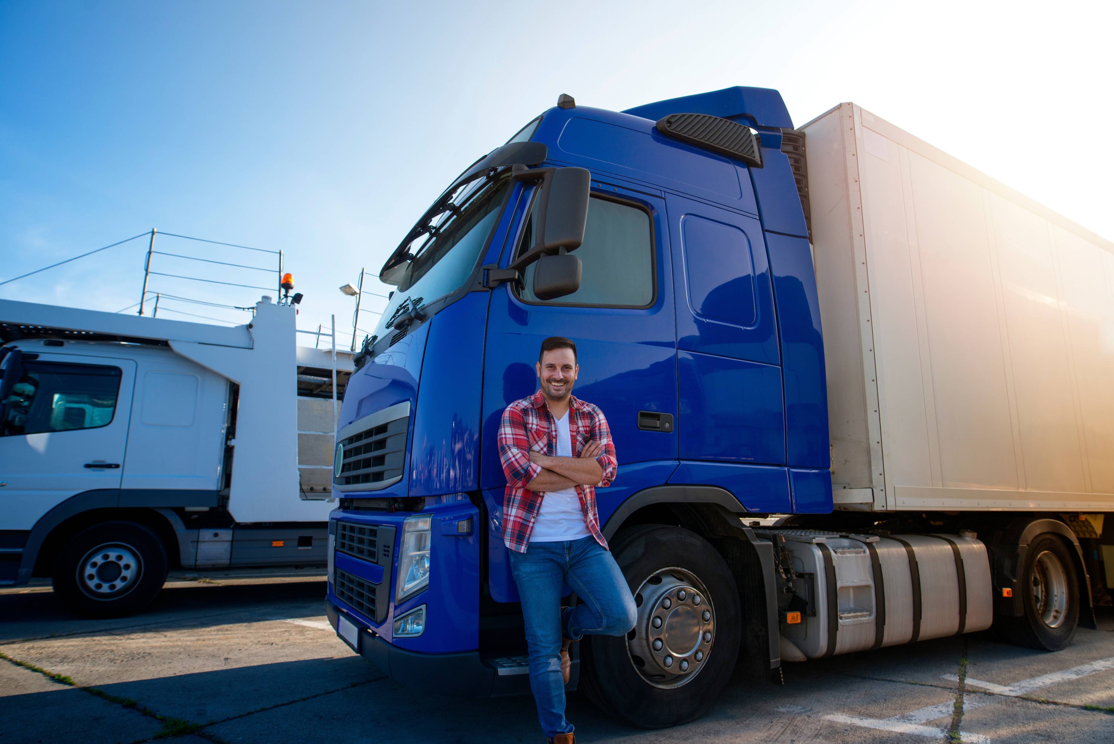 A man leaning against a large semi truck