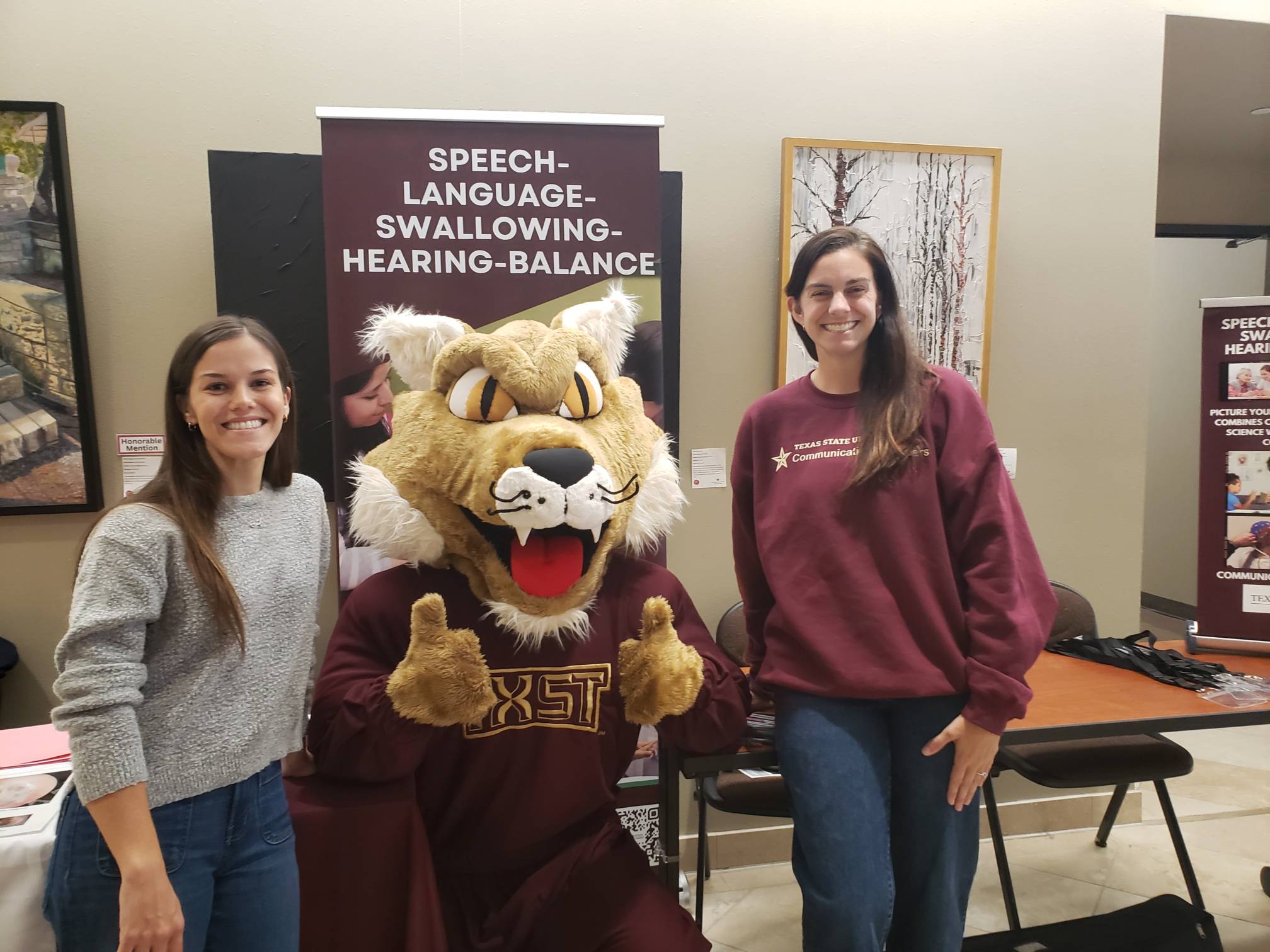 CDIS students posing next to Boko, the Bobcat during the event.