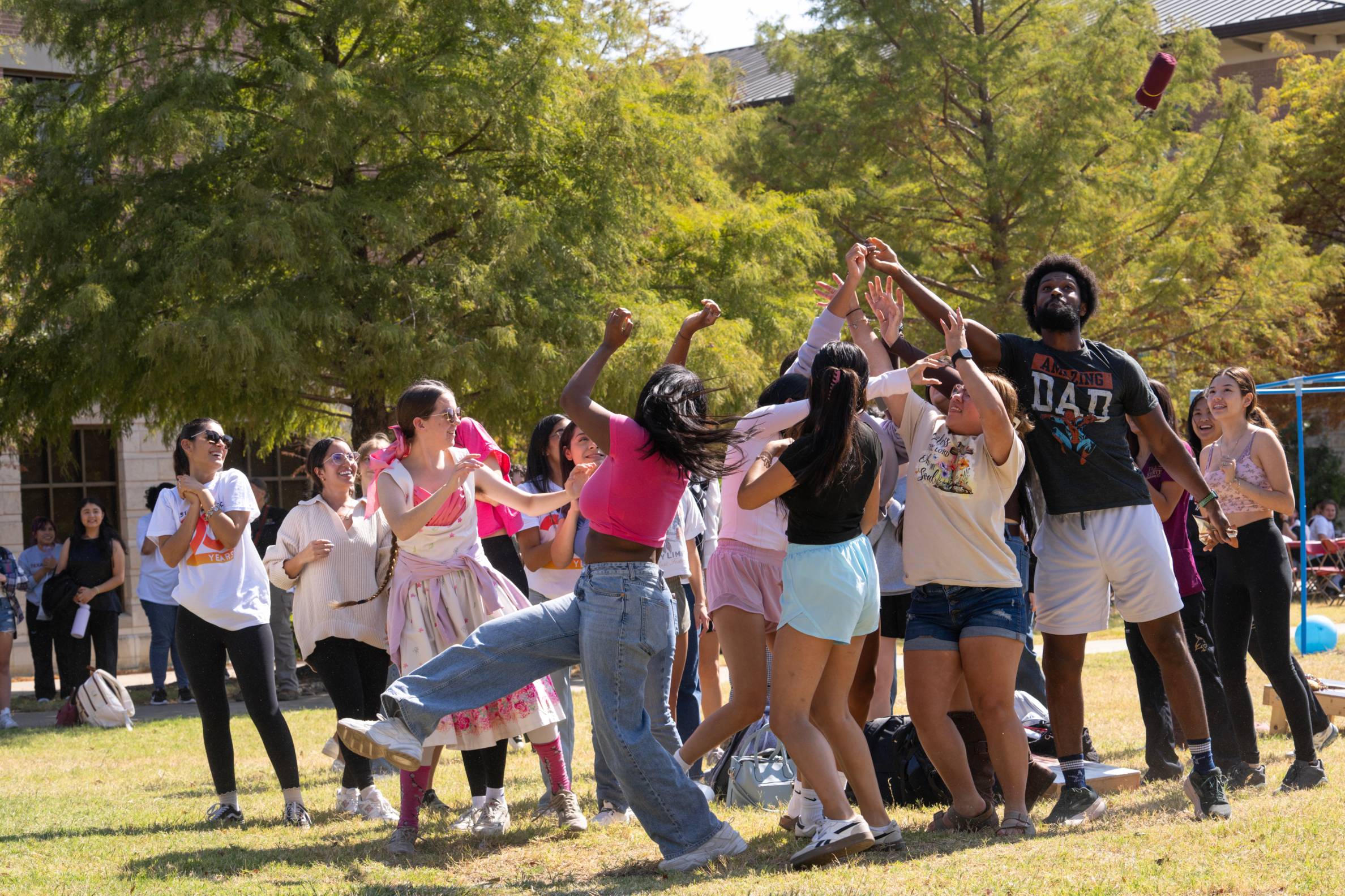 a crowd trying to catch a shirt