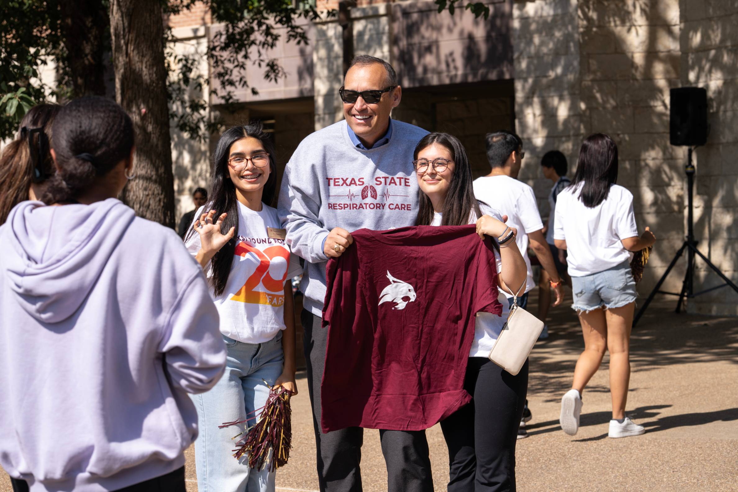 students taking picture with the president Kelly