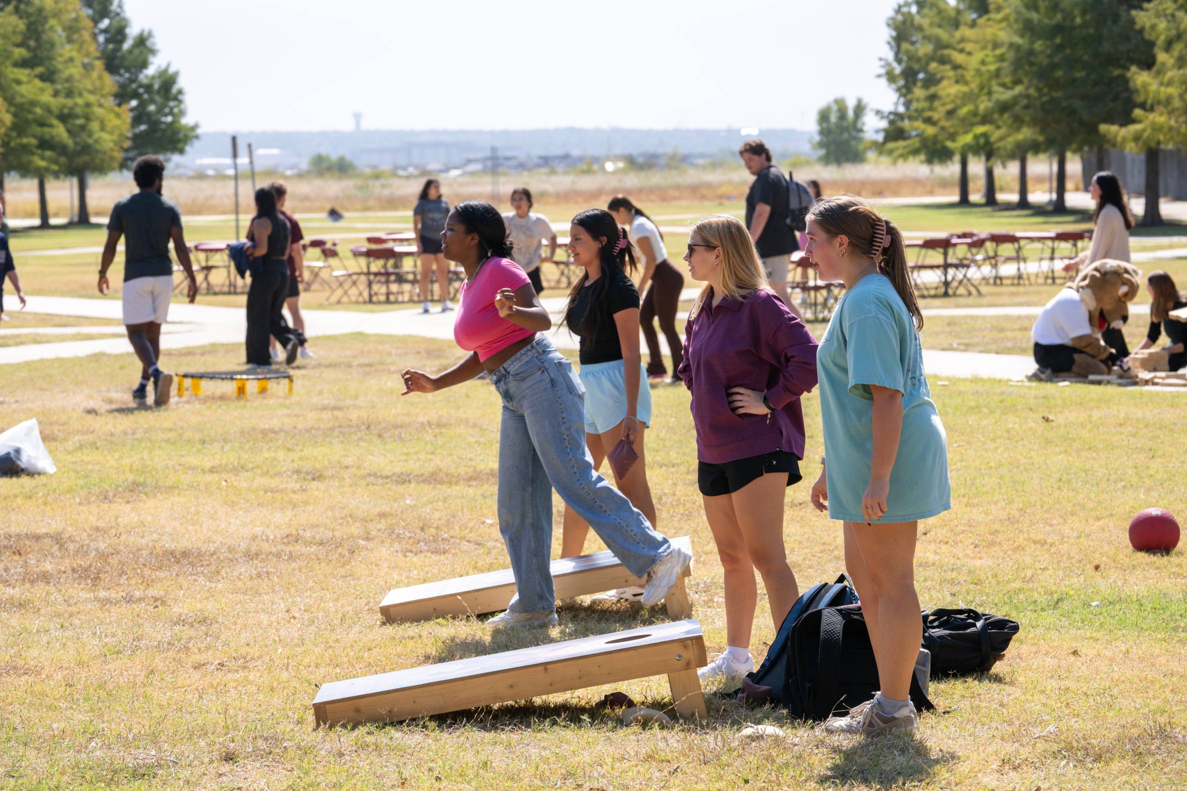 students playing cornhole