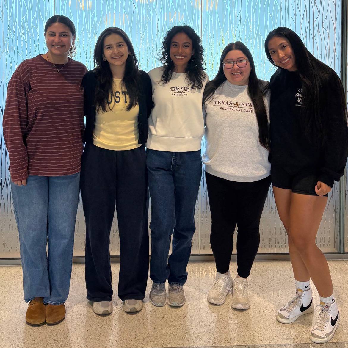 Ashley Harmell (left), Monica Pacheco, Elisa Sanchez, Bianca Cepeda, and Eliana Hernandez pose for a photo together.