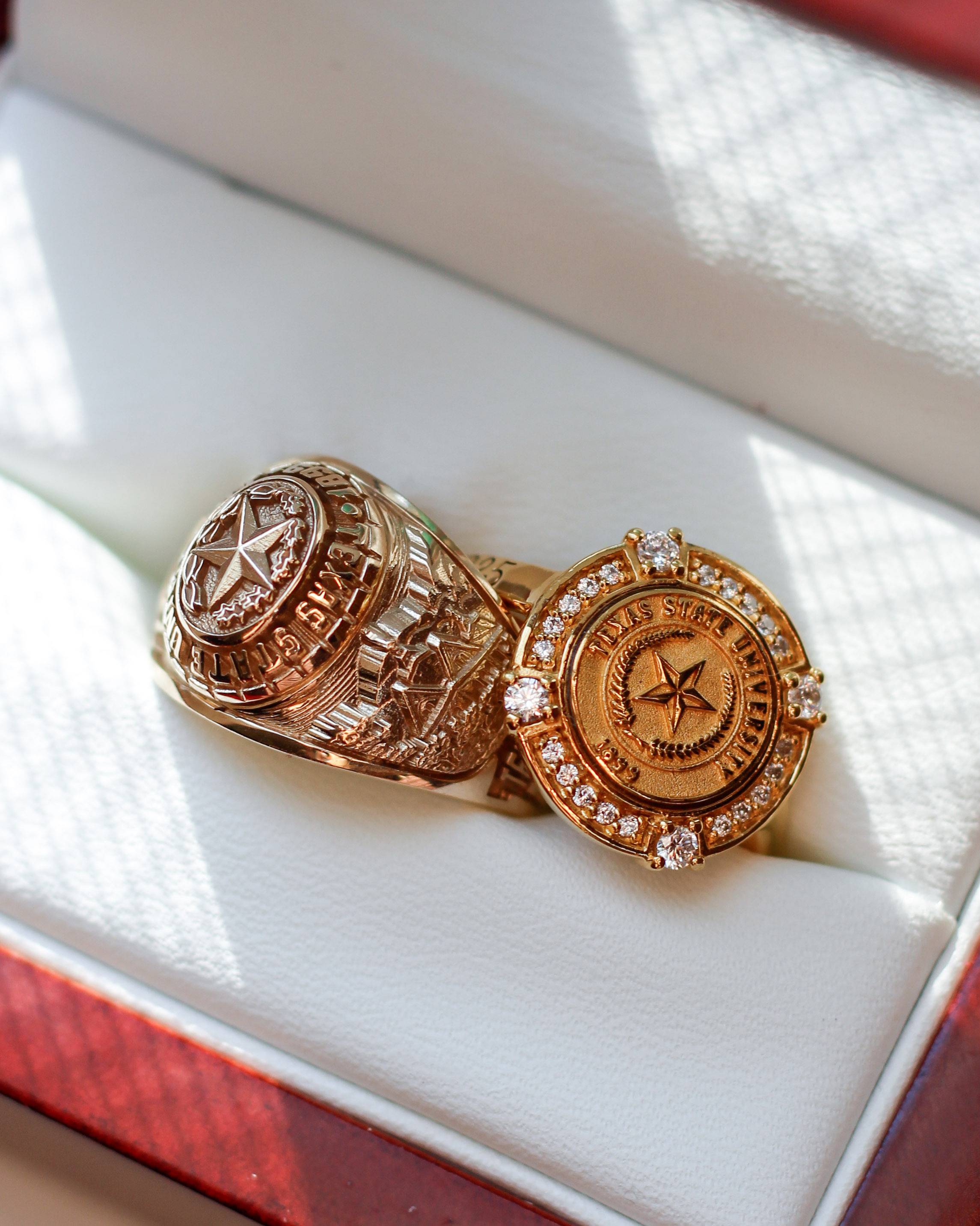 Two official Texas State class rings in a ring box