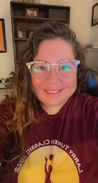 closeup of woman wearing glasses smiling at camera