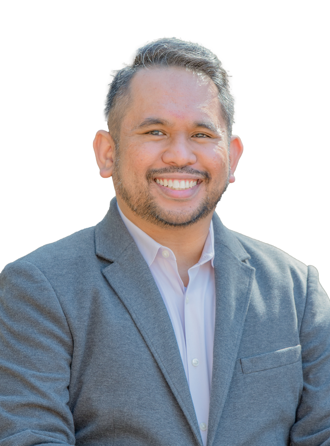 man smiling at camera wearing a gray blazer over a light button up shirt