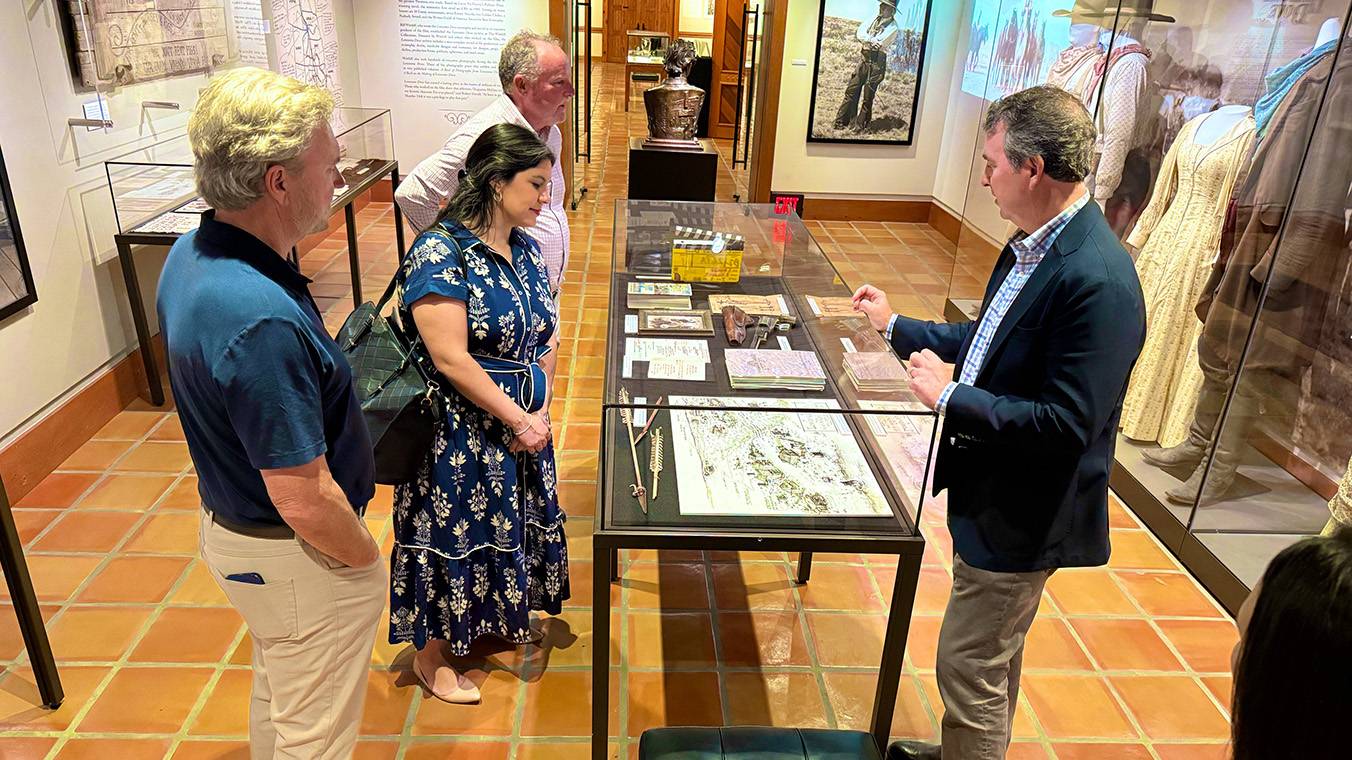 A group of staff from the Meadows Center looks at an exhibit at The Wittliff Collections.