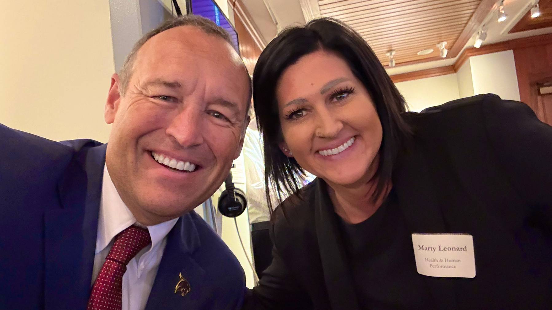 President Kelly Damphousse (left) poses for a photo with Marty Leonard.