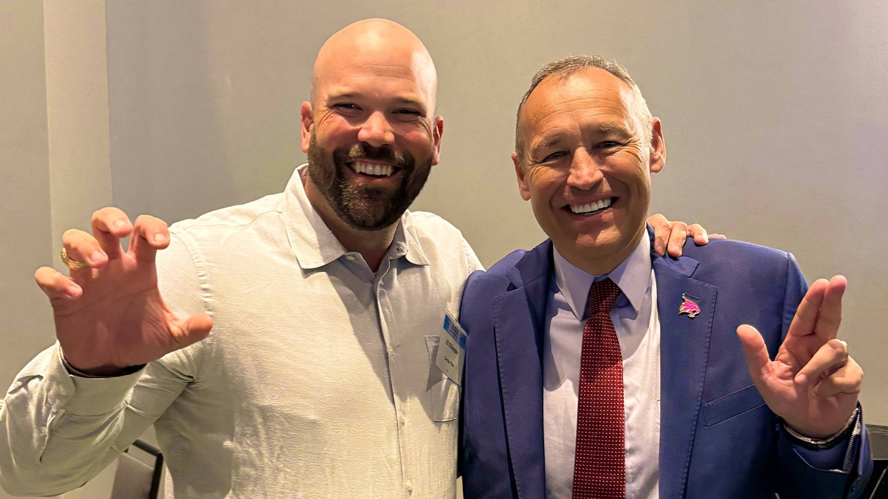 President Kelly Damphousse (right) poses for a picture with an attendee at the summit.