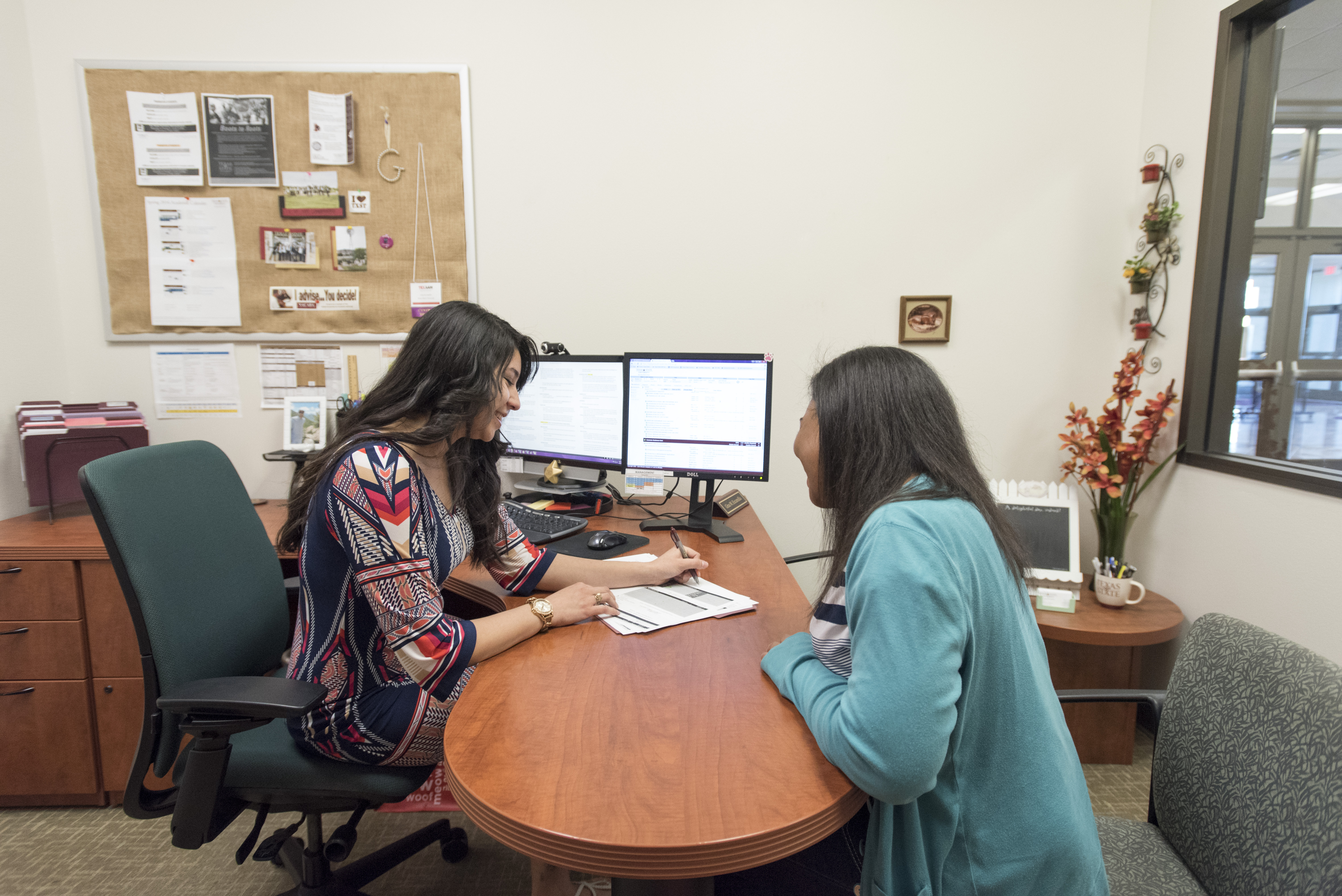 Advisor and student in office