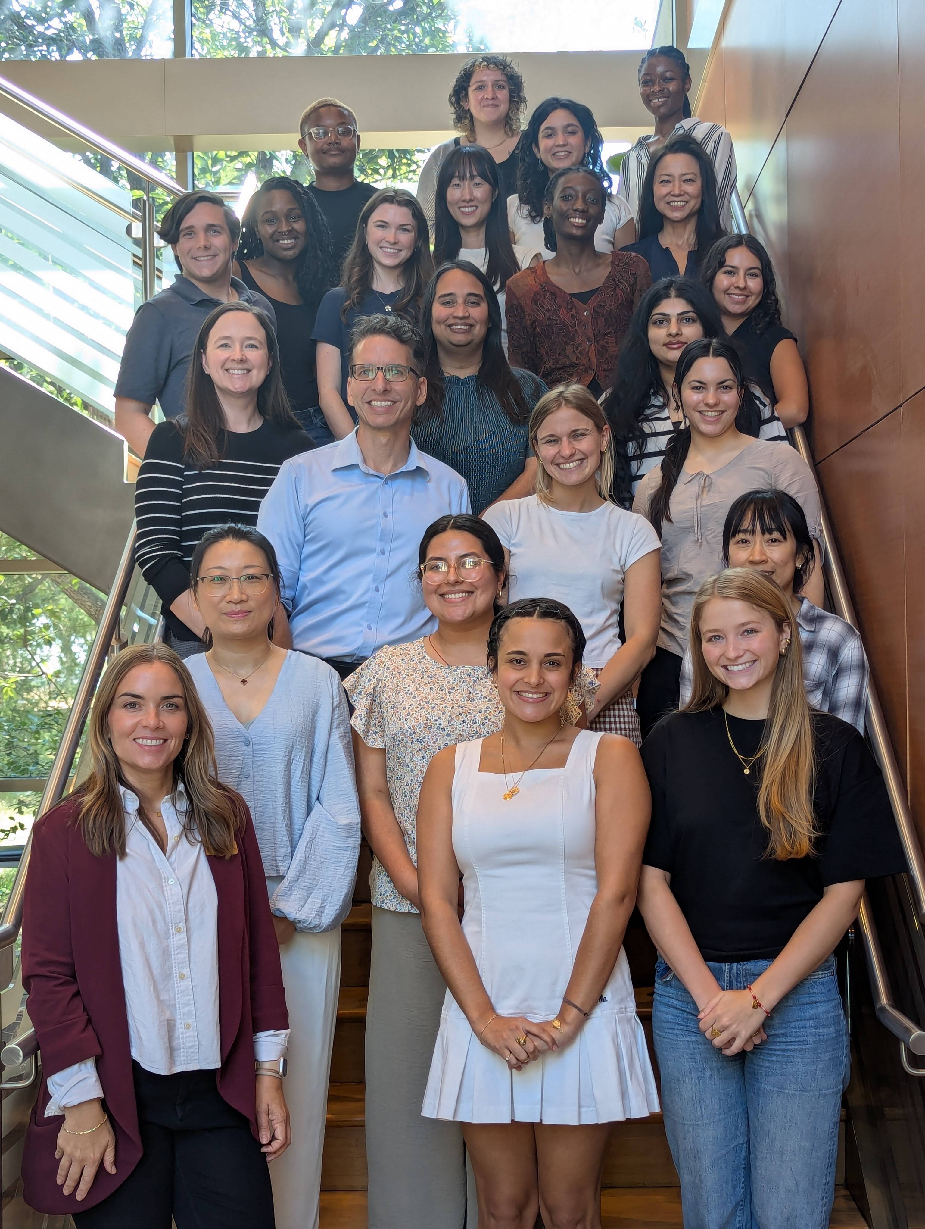 HDFS Faculty and REU Fellowships standing on a staircase