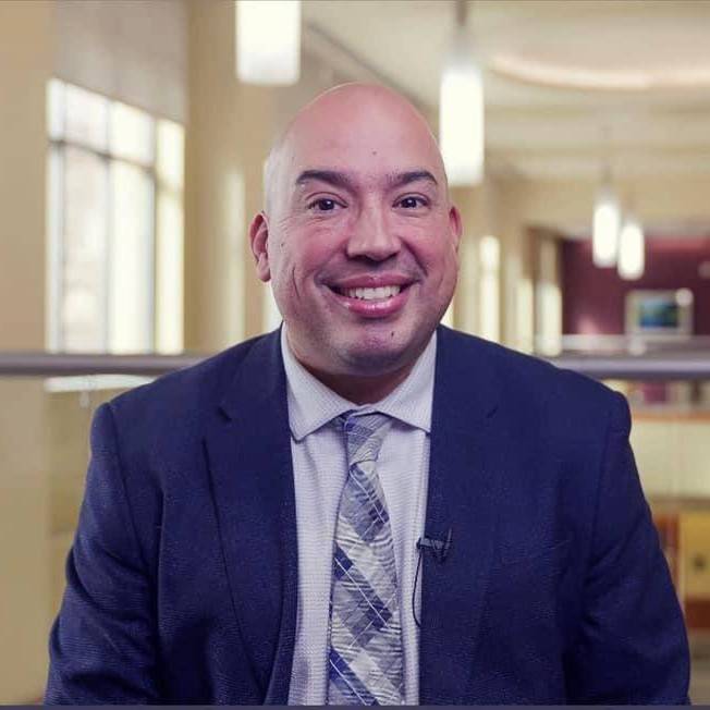 bald man in suit and tie