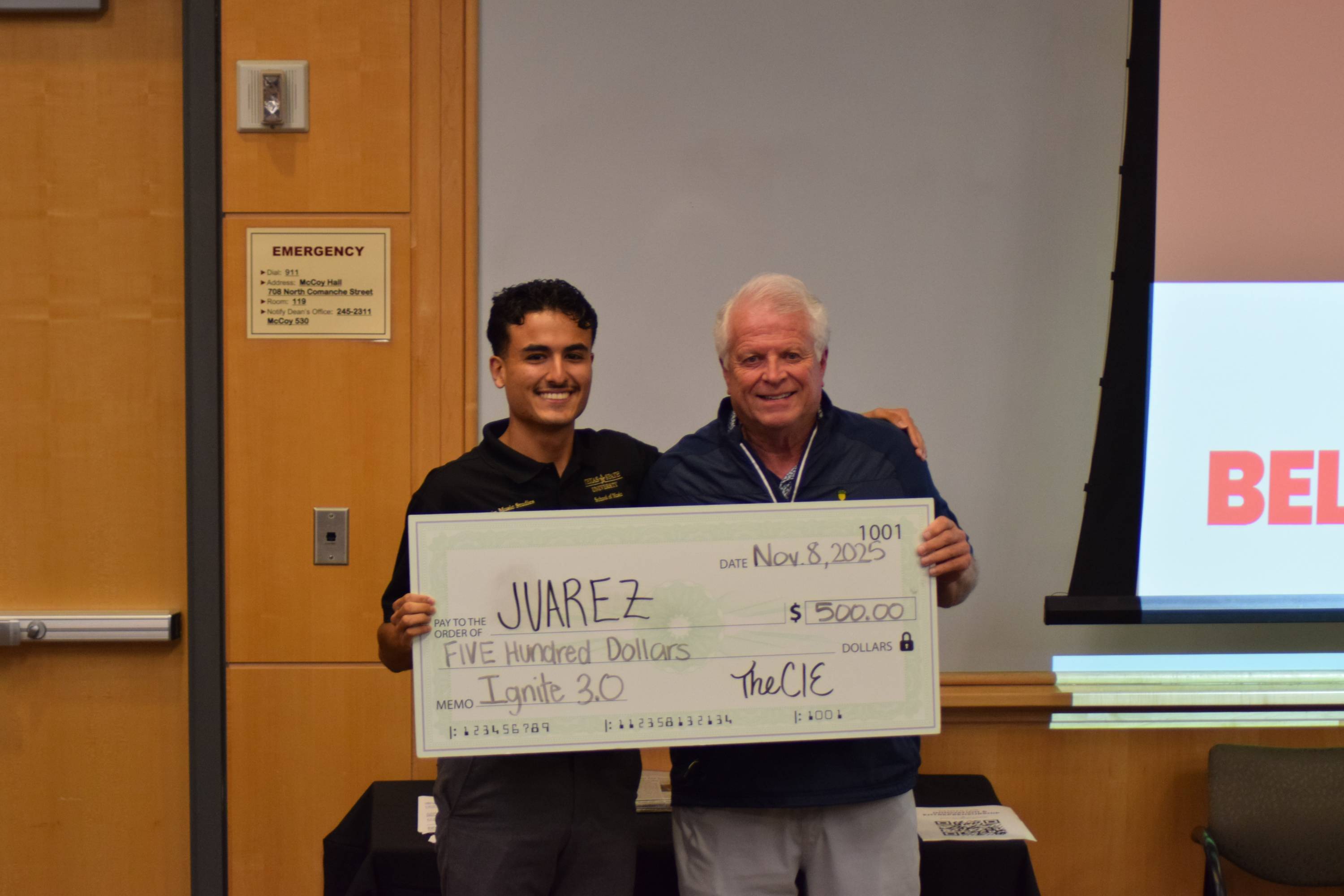Juarez posing with a judge after being awarded second place at the Ignite 3.0 pitch competition.