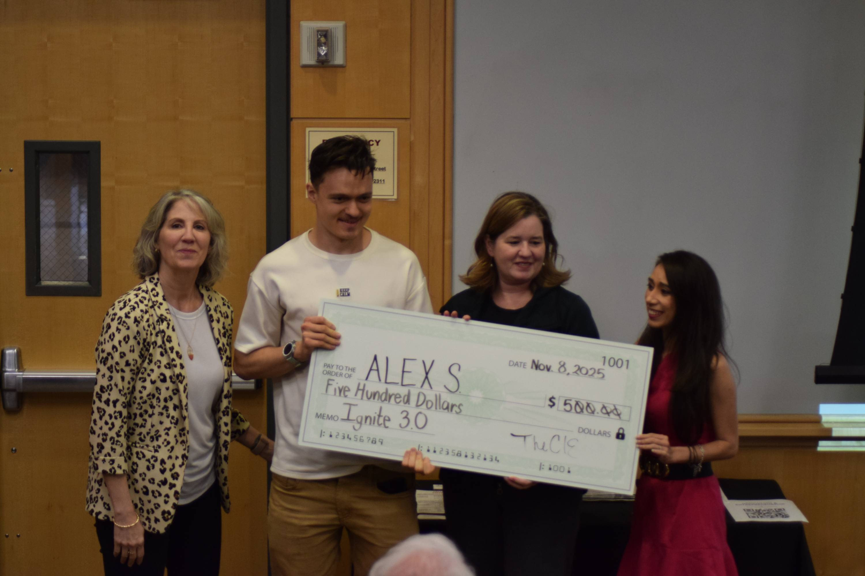 Alex Syzoy poses with judges after winning second place at the Ignite 3.0 pitch competition.