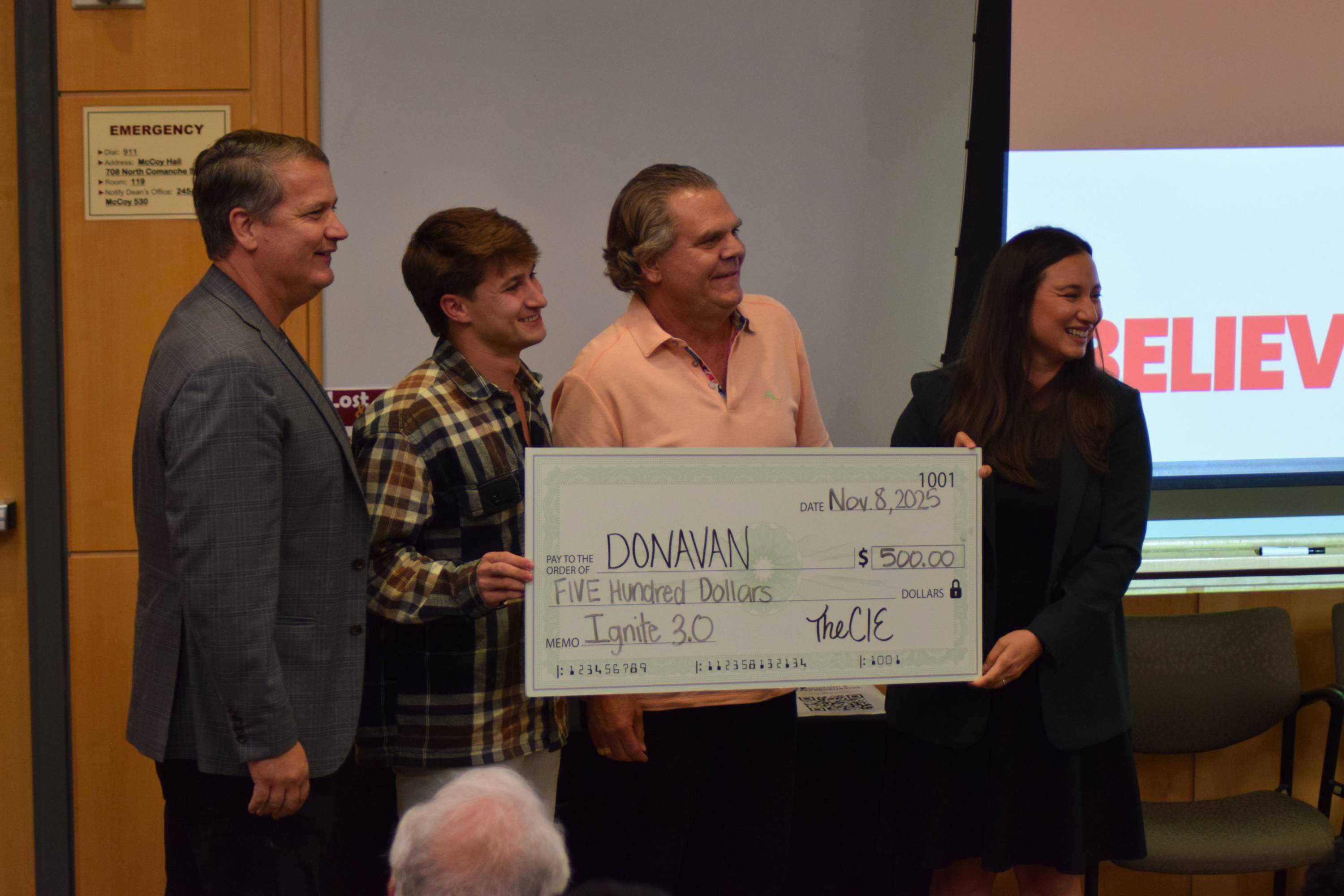 Donavan J. Brown poses with judges after winning second place at the Ignite 3.0 pitch competition.