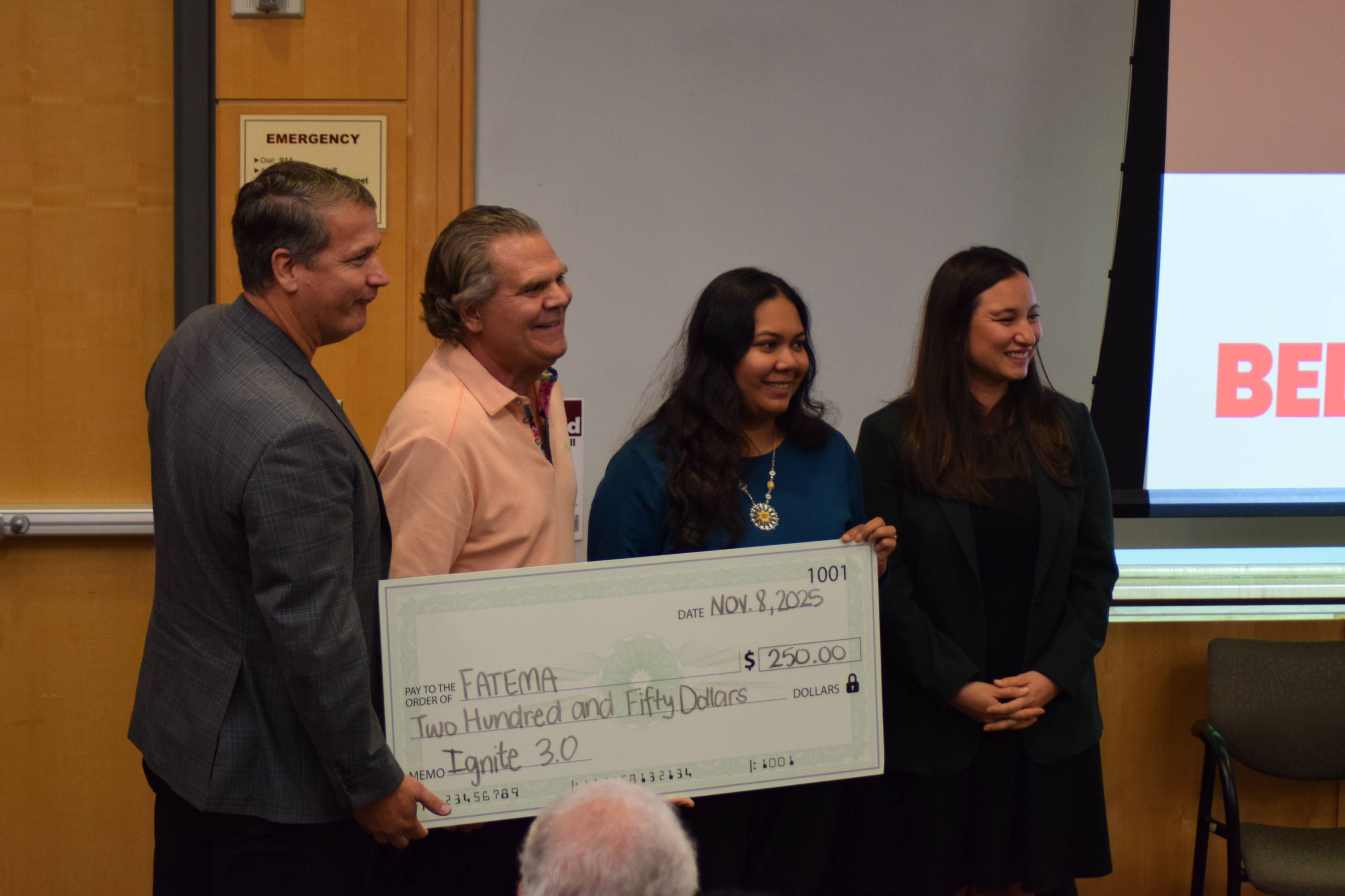 Fatem Zahara poses with judges after winning third place at the Ignite 3.0 pitch competition.