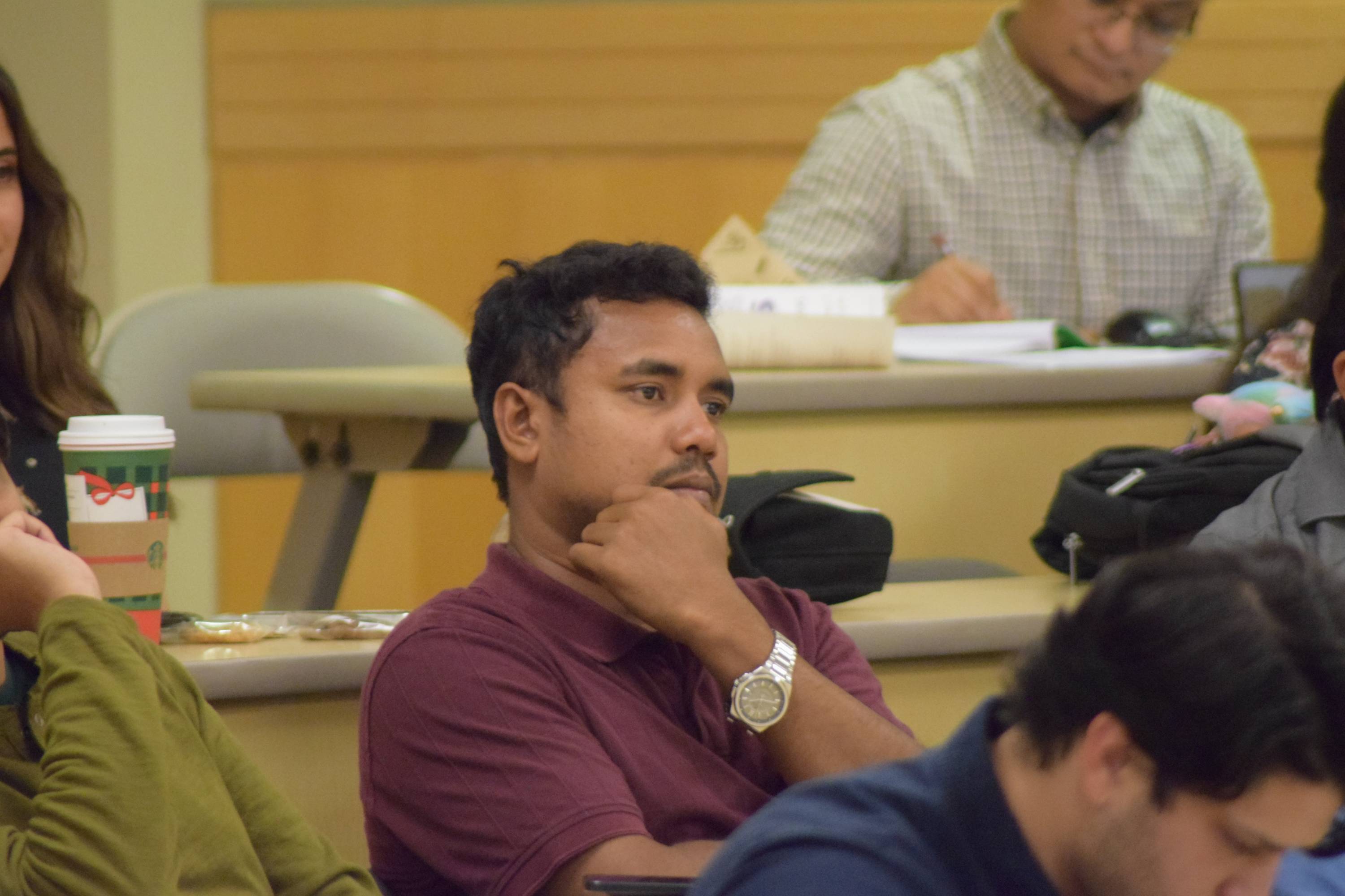 Audience member at Ignite 3.0 listening to a presentation.