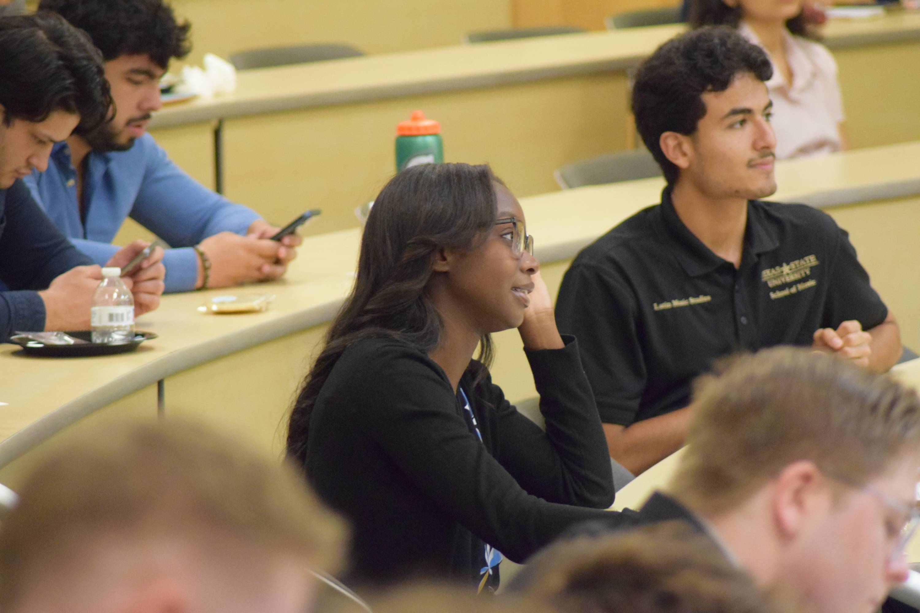 Audience member listening to a presentation at the Ignite 3.0 event.