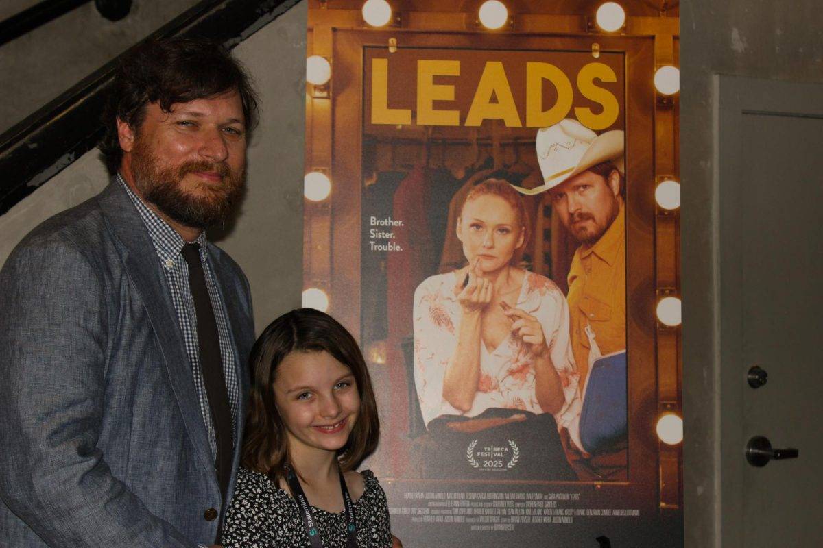 “Leads” director Bryan Poyser (left) and his daughter Hazel Poyser (center) pose with the film’s poster at its premiere, Sunday, October 26, 2025, at the 32rd annual Austin Film Festival.