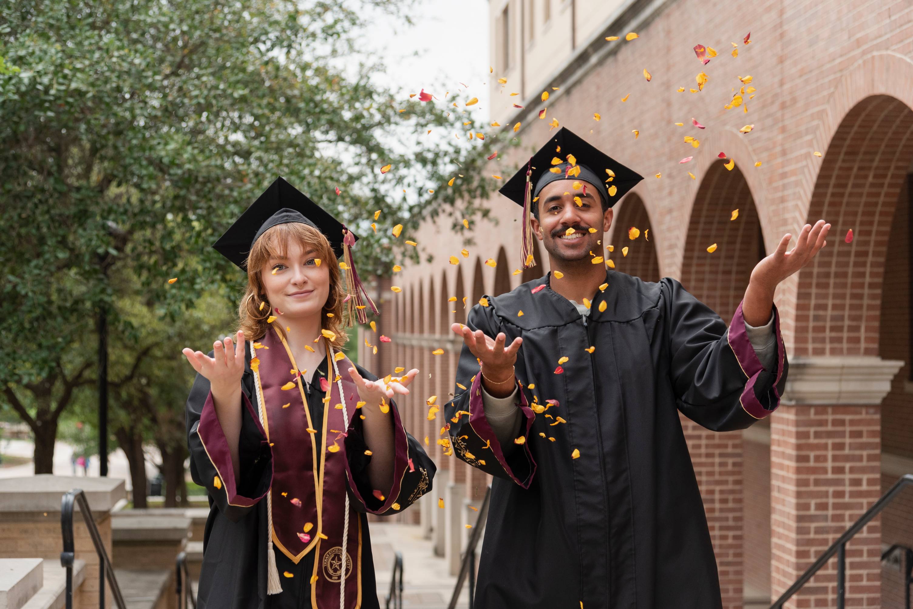 graduates throwing glitter