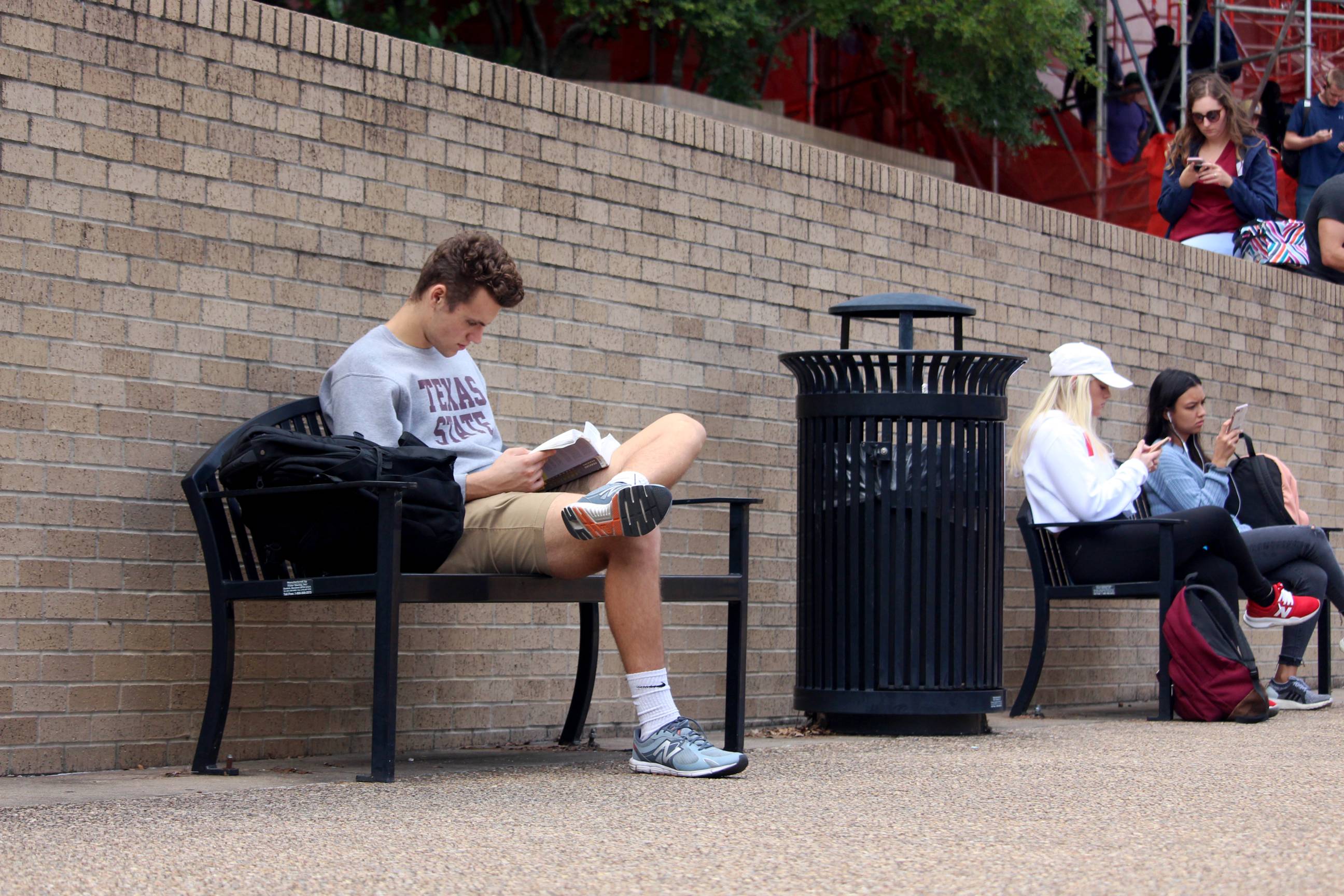 trash can and students on campus