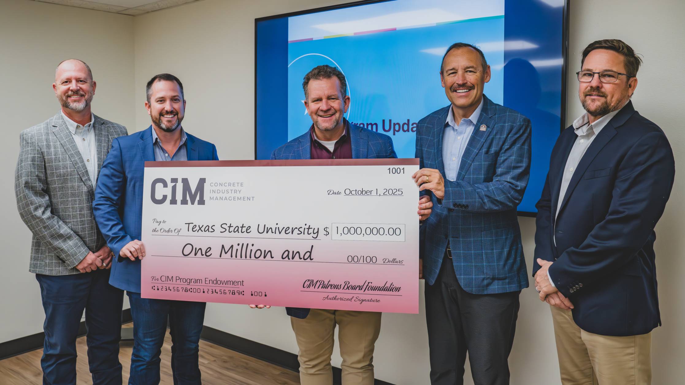 five men in business attire hold up large check