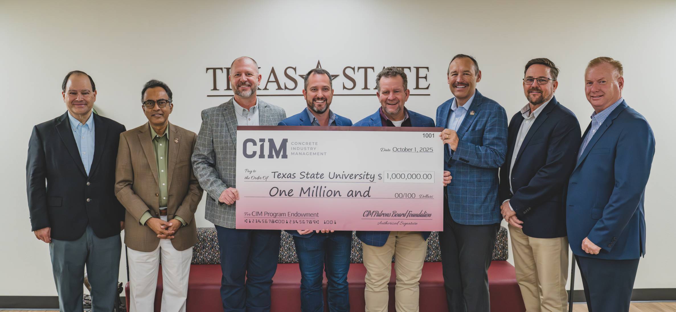 faculty members holding an endowment check