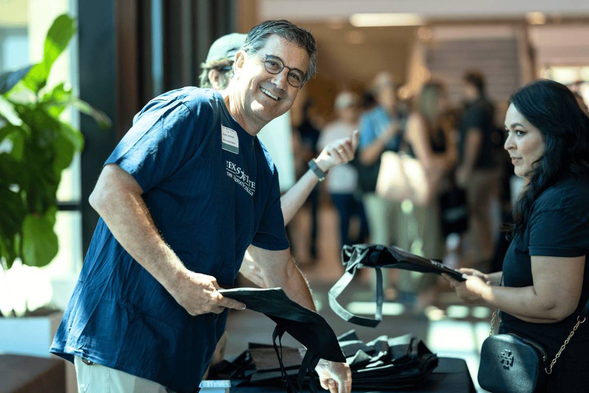A professor guiding a student in the classroom