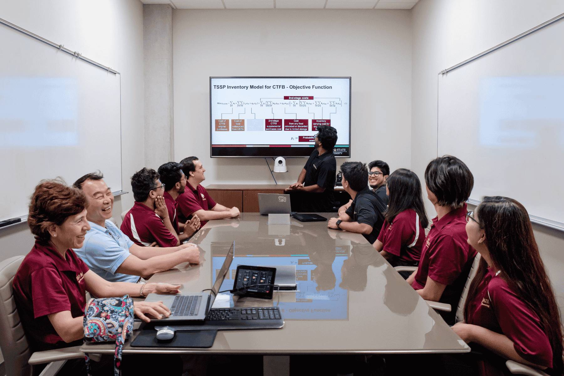 A student sitting at a desk working on a computer.
