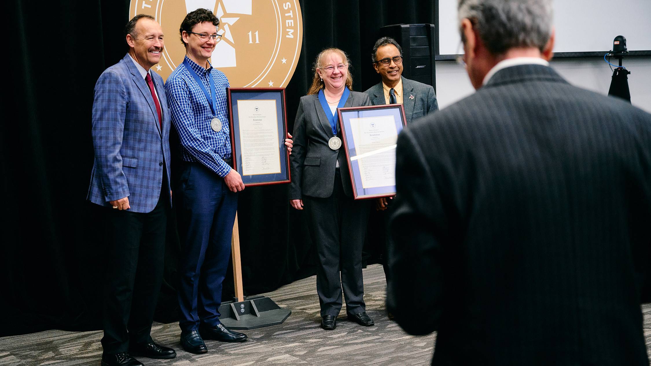 President Kelly Damphousse, Oleg Komogortsev, Susan Morey, and Pranesh Aswath pose for a photo.